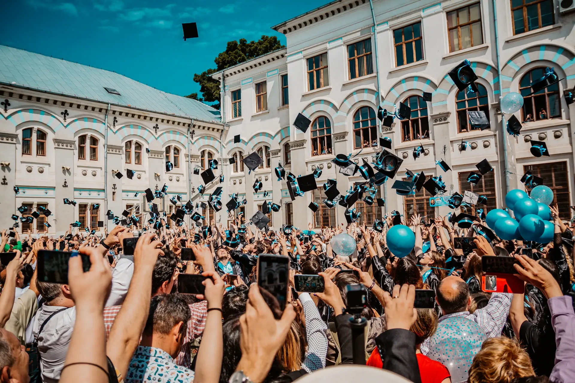 Graduates throwing caps into the air