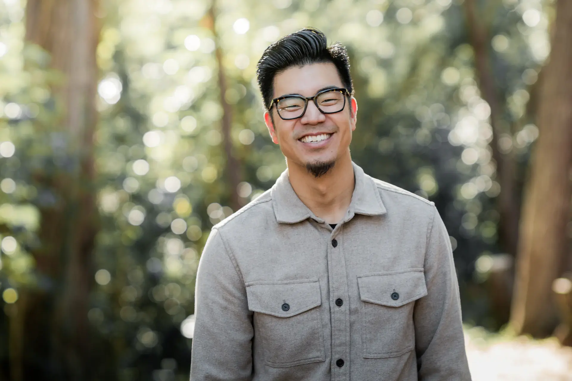 Confident male student smiling outdoors