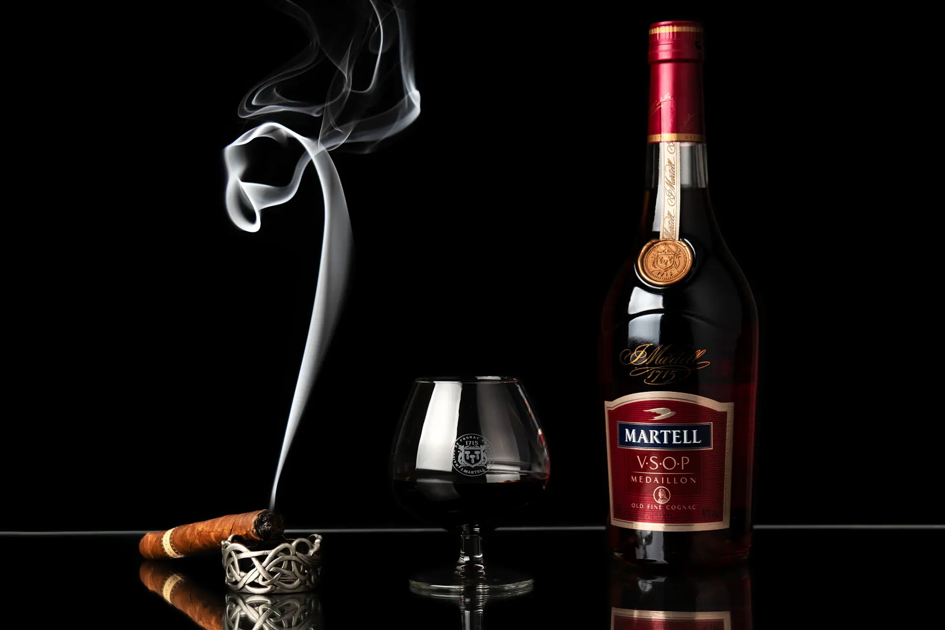 A snifter of aged cognac glowing amber in low light