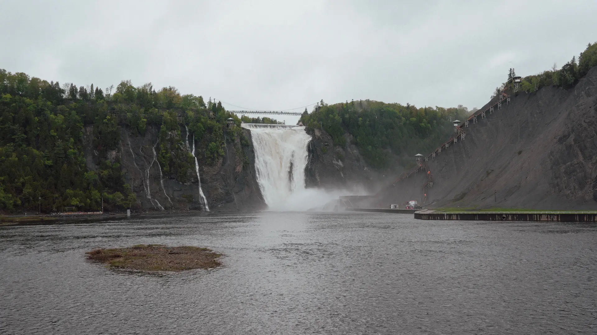 Mist filling a wide basin beneath a roaring fall