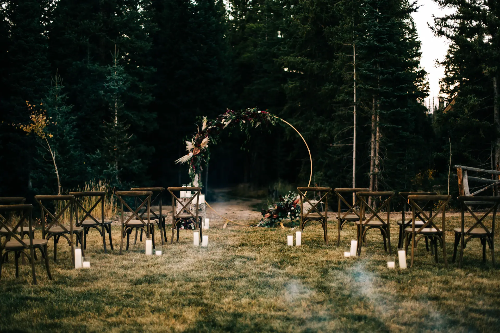A candlelit ceremony aisle in a marble hall