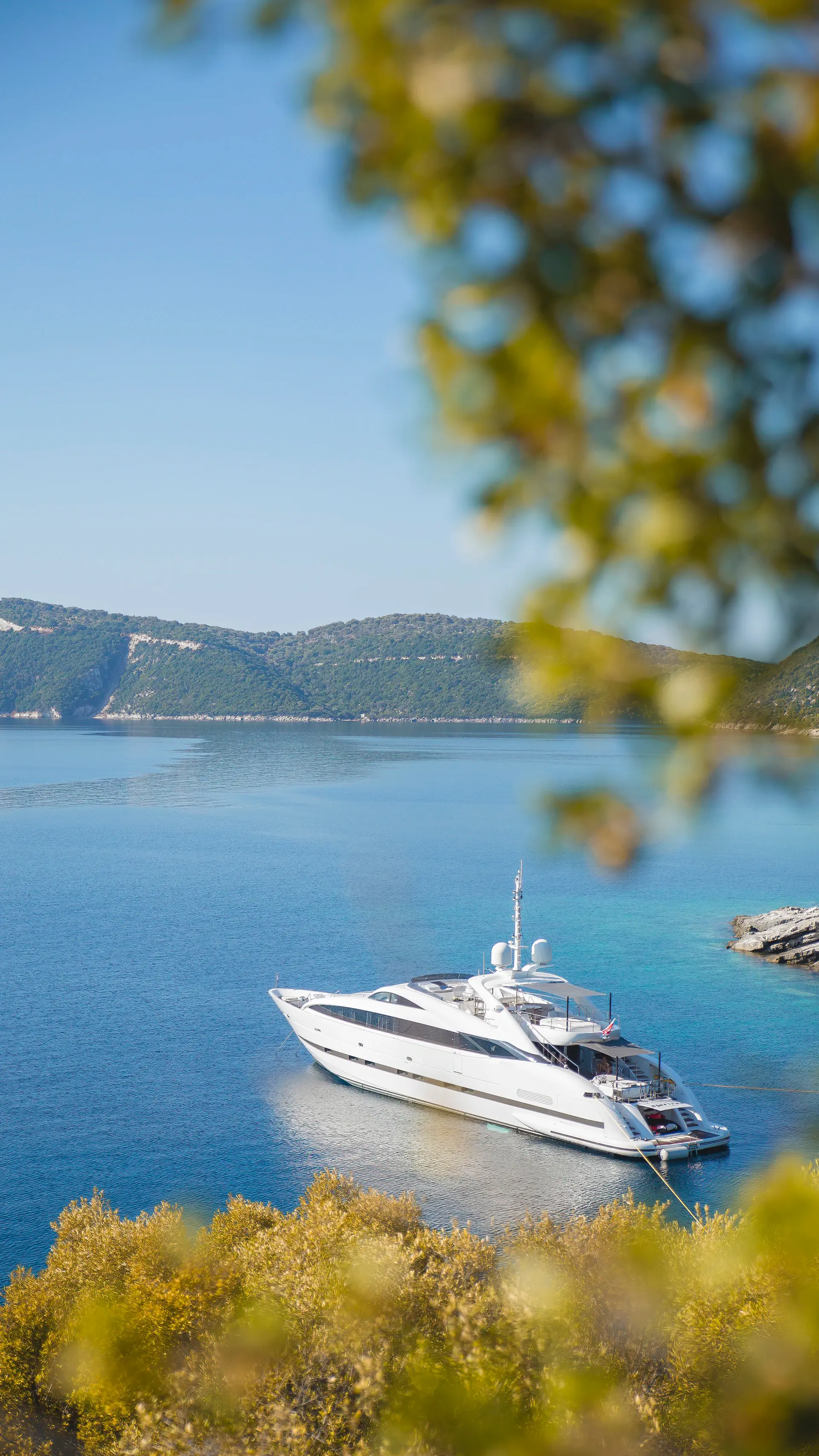 Yacht resting in a hidden turquoise bay