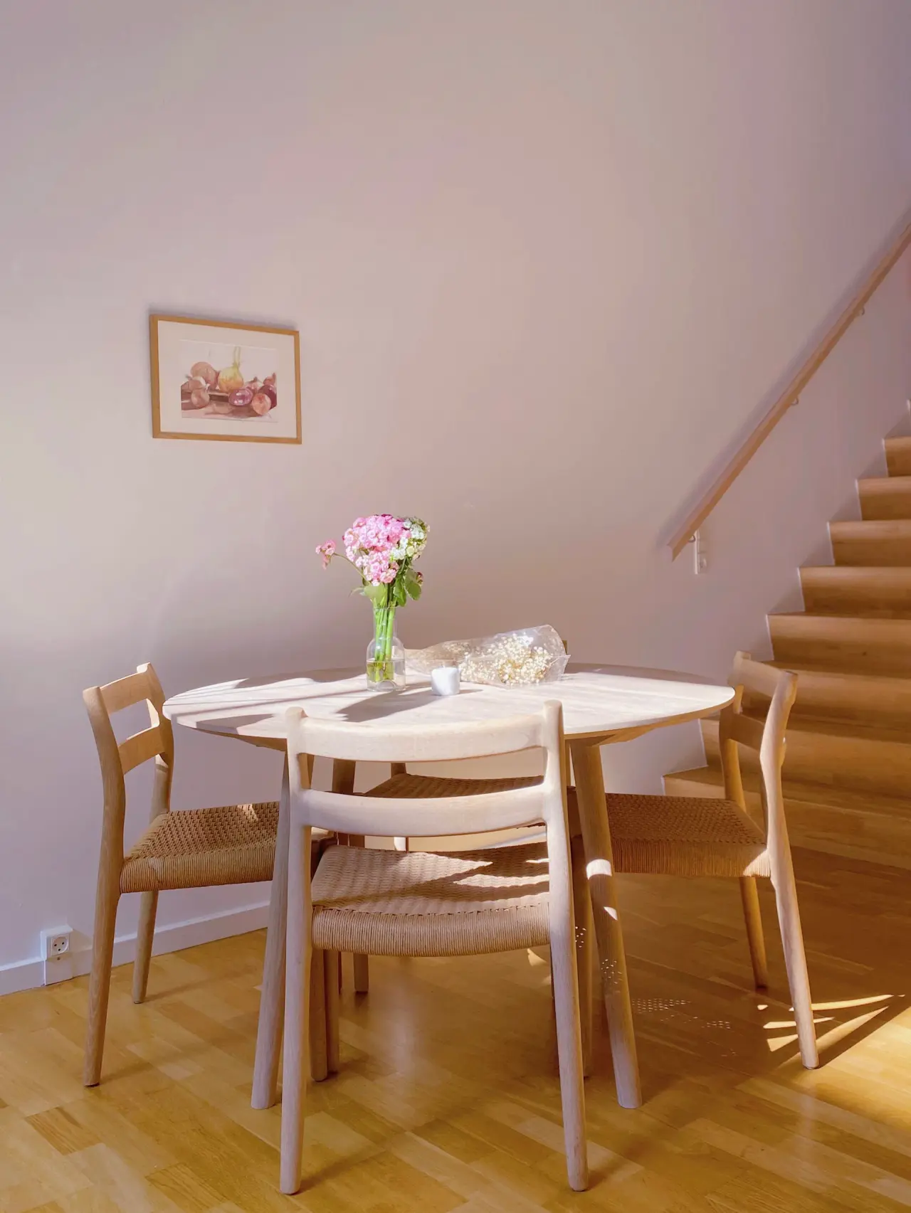 Blush rose against a neutral wall