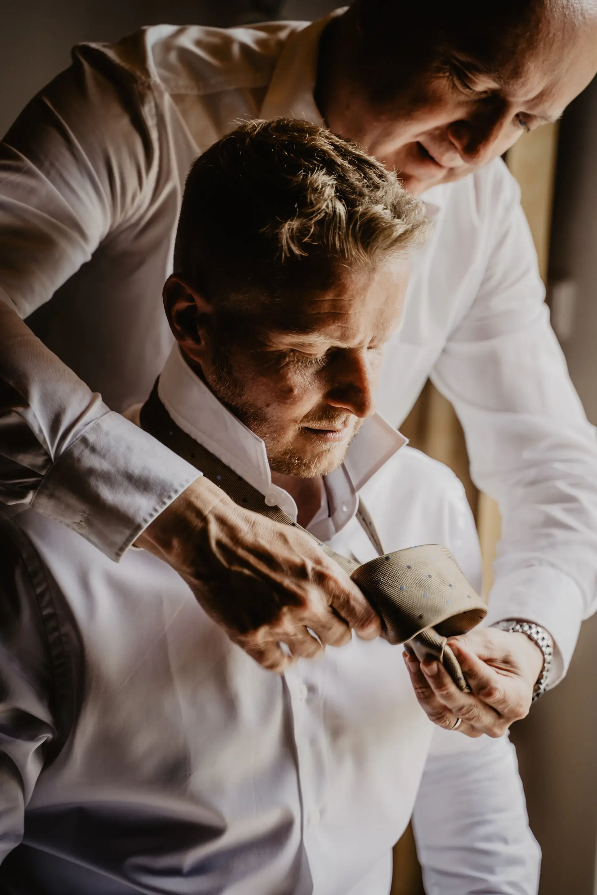 Groom adjusting cufflinks