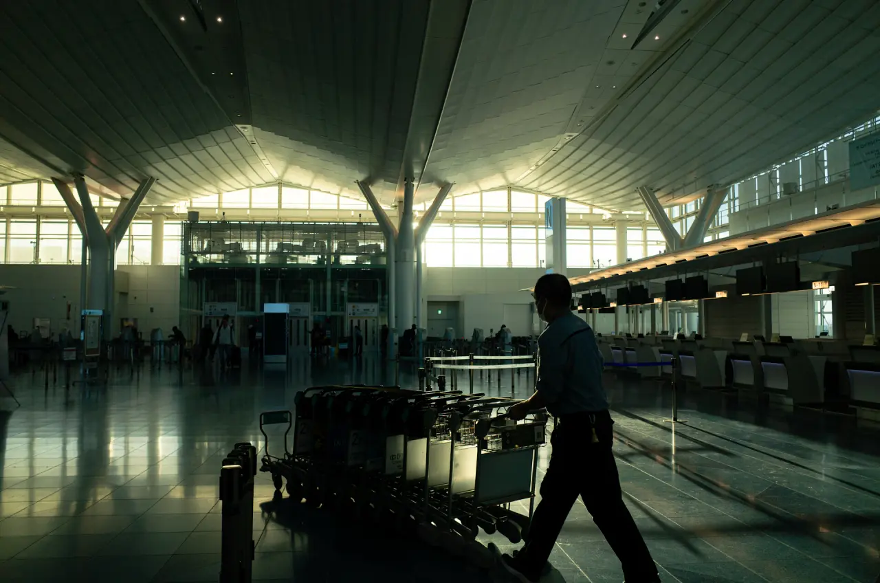 Student arriving at an international airport with luggage