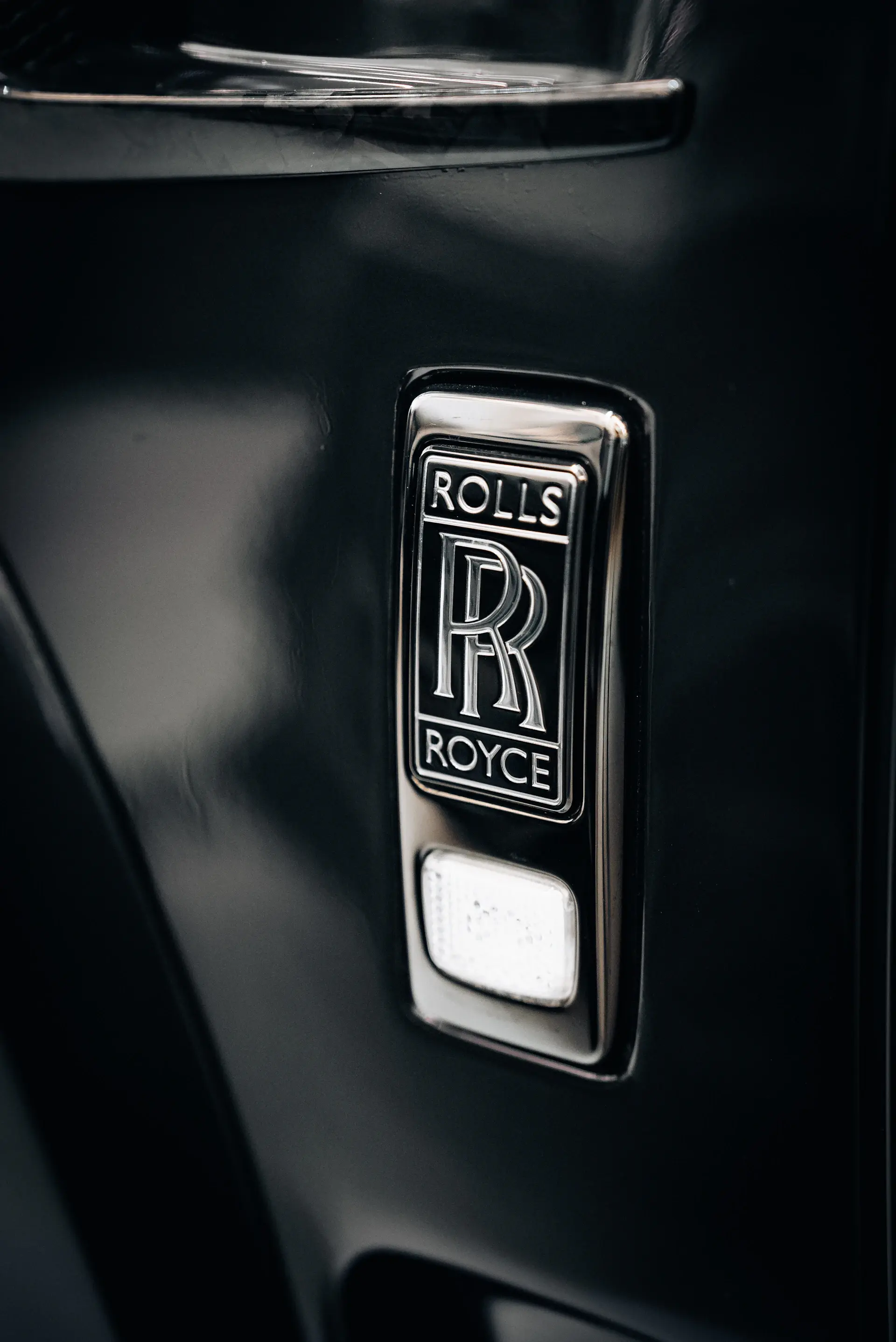 Engraved metal nameplate on a luxury motorcar