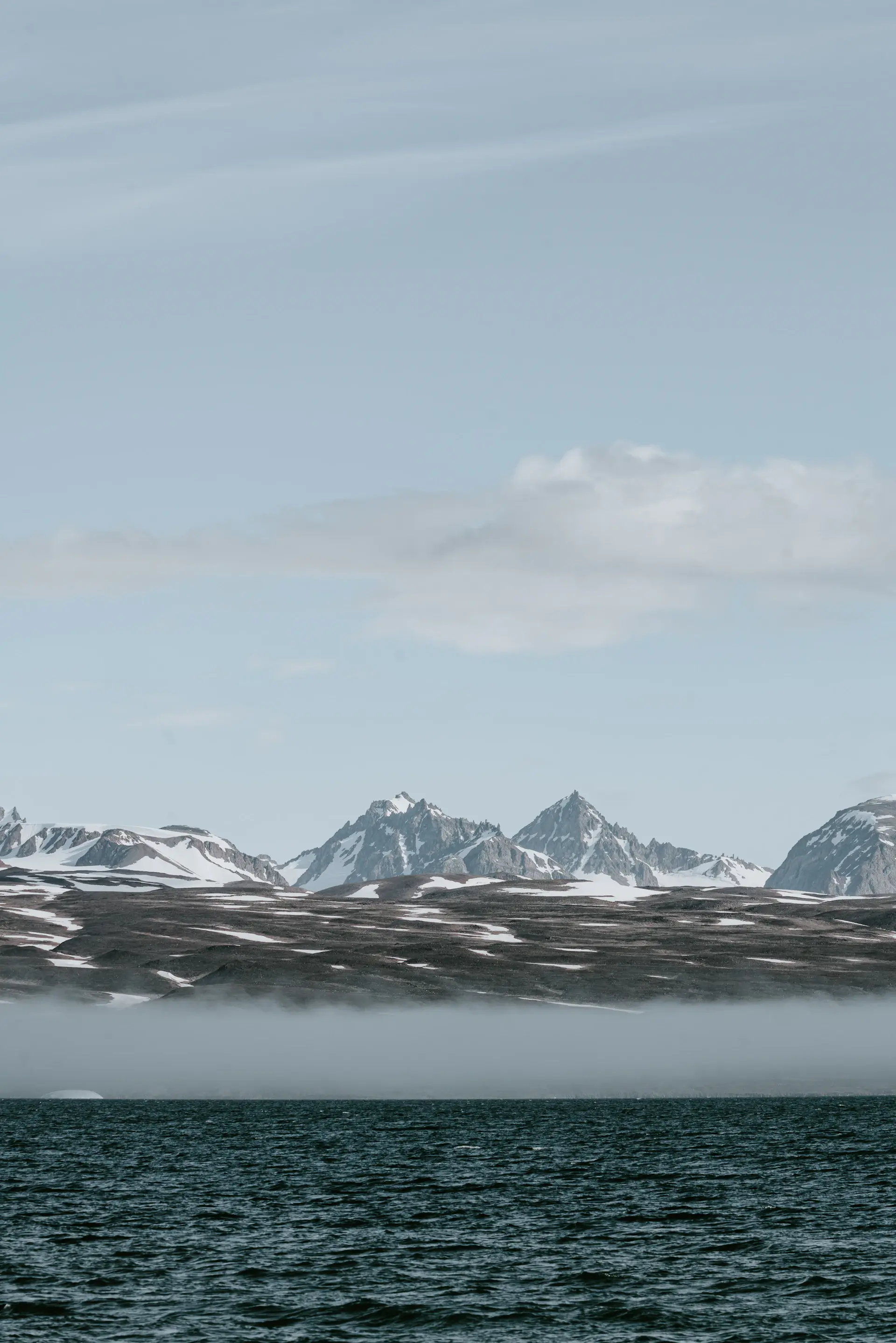An icebound Arctic fjord under a pale polar sky