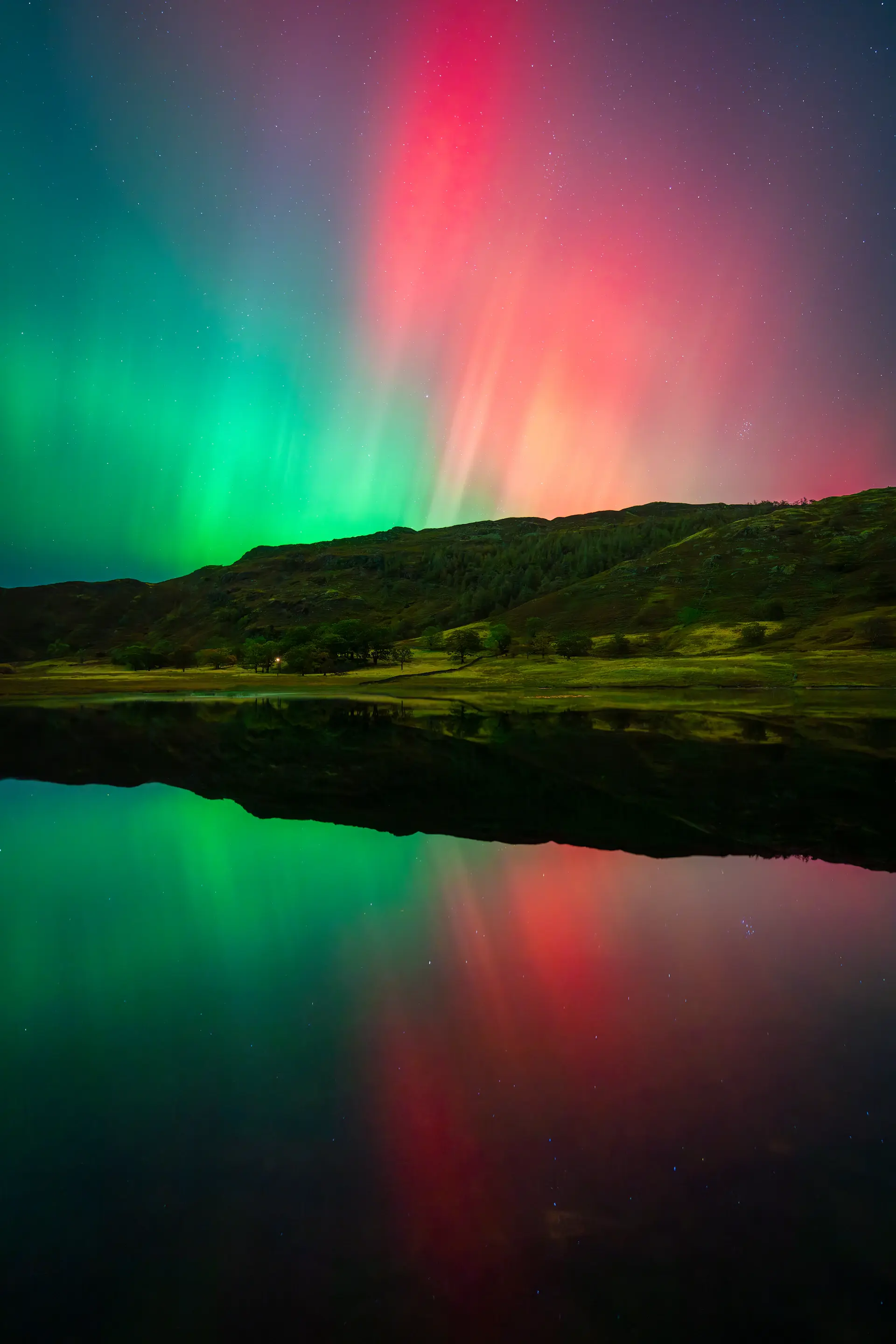 Endless polar light over a still mirror-calm bay