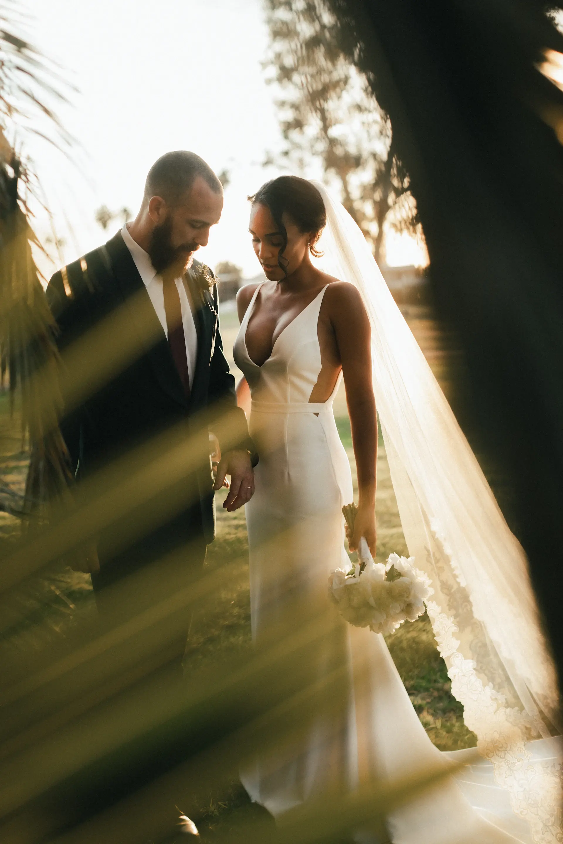 The couple exchanging vows beneath soft light