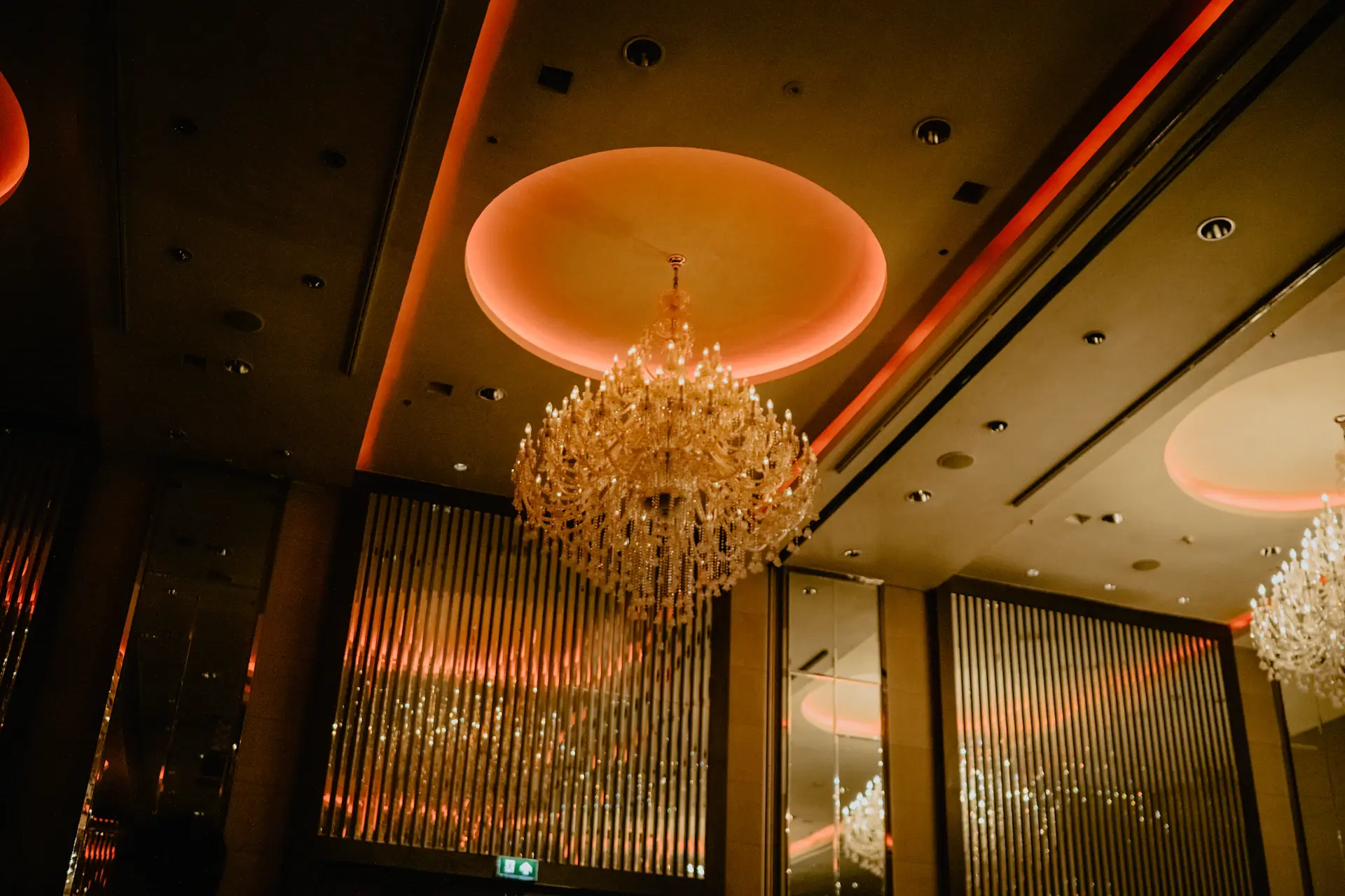 A grand crystal-lit ballroom dressed for a wedding