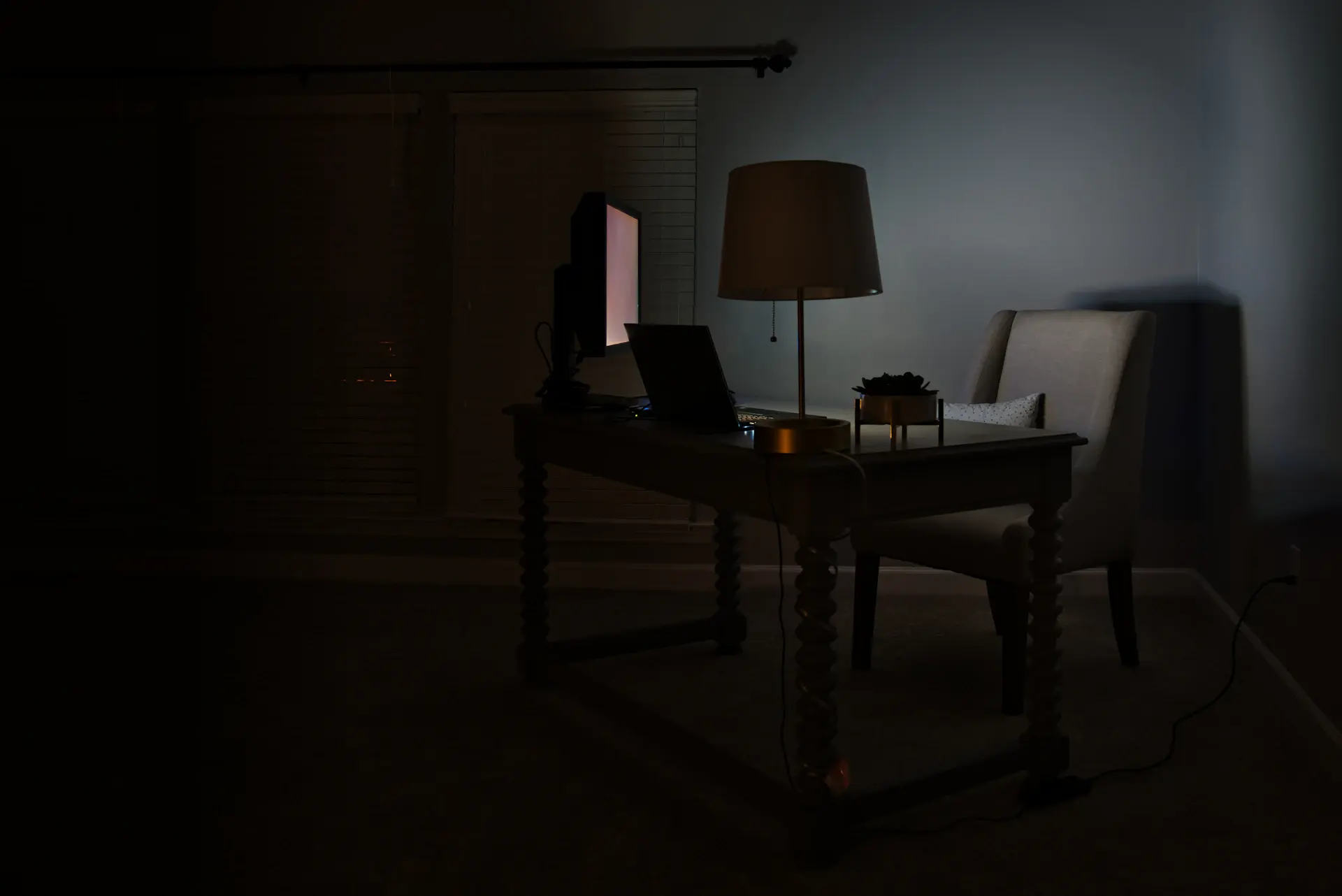 Private salon with a quiet desk and soft evening light