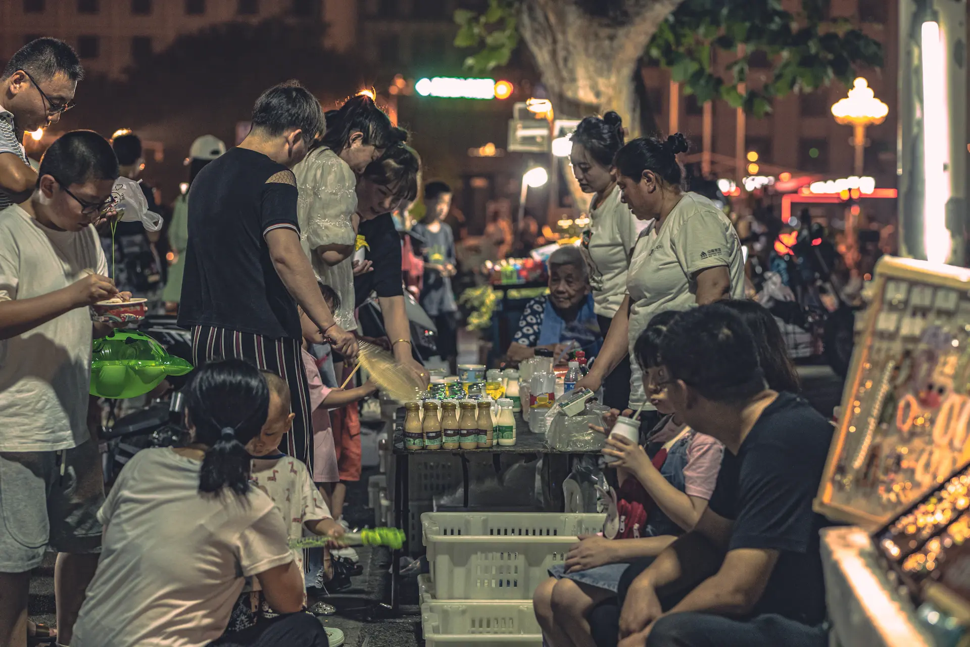 Students enjoying street food at a night market in China