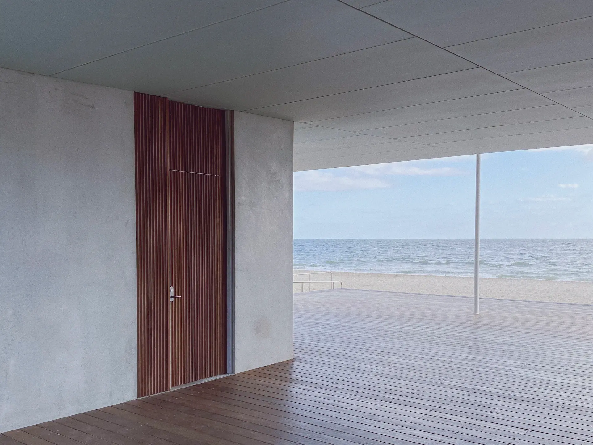Living room with floor-to-ceiling windows and sea view