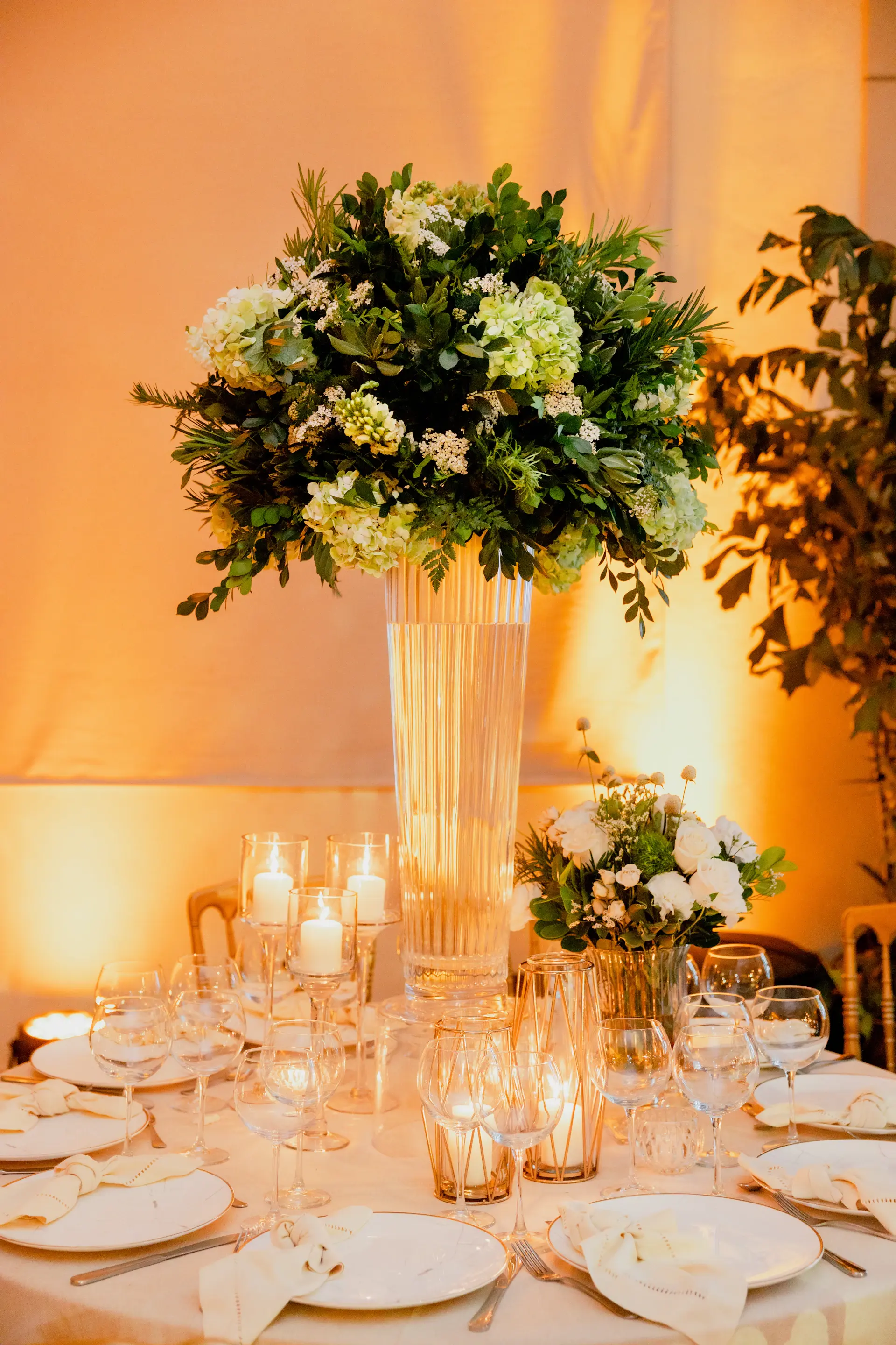 Lush floral centerpiece on a candlelit dining table