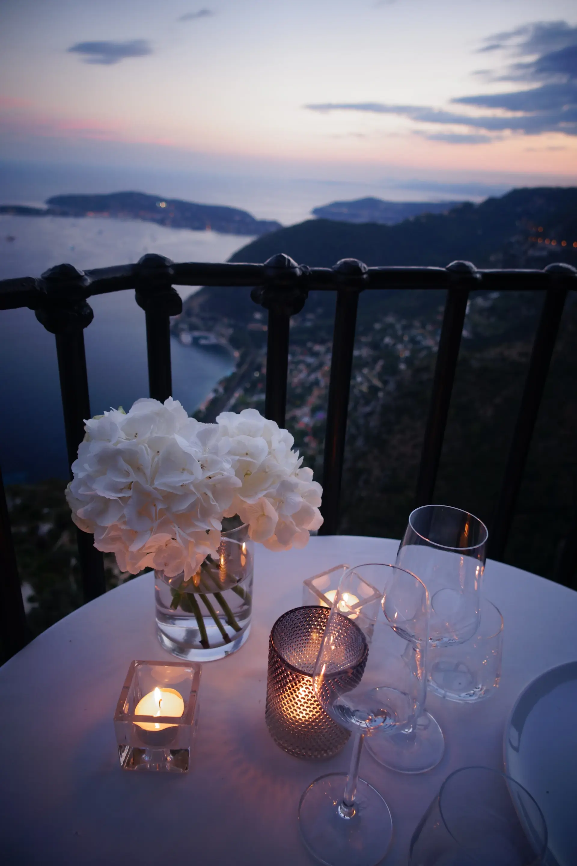 Rose bouquet on a candlelit dining table