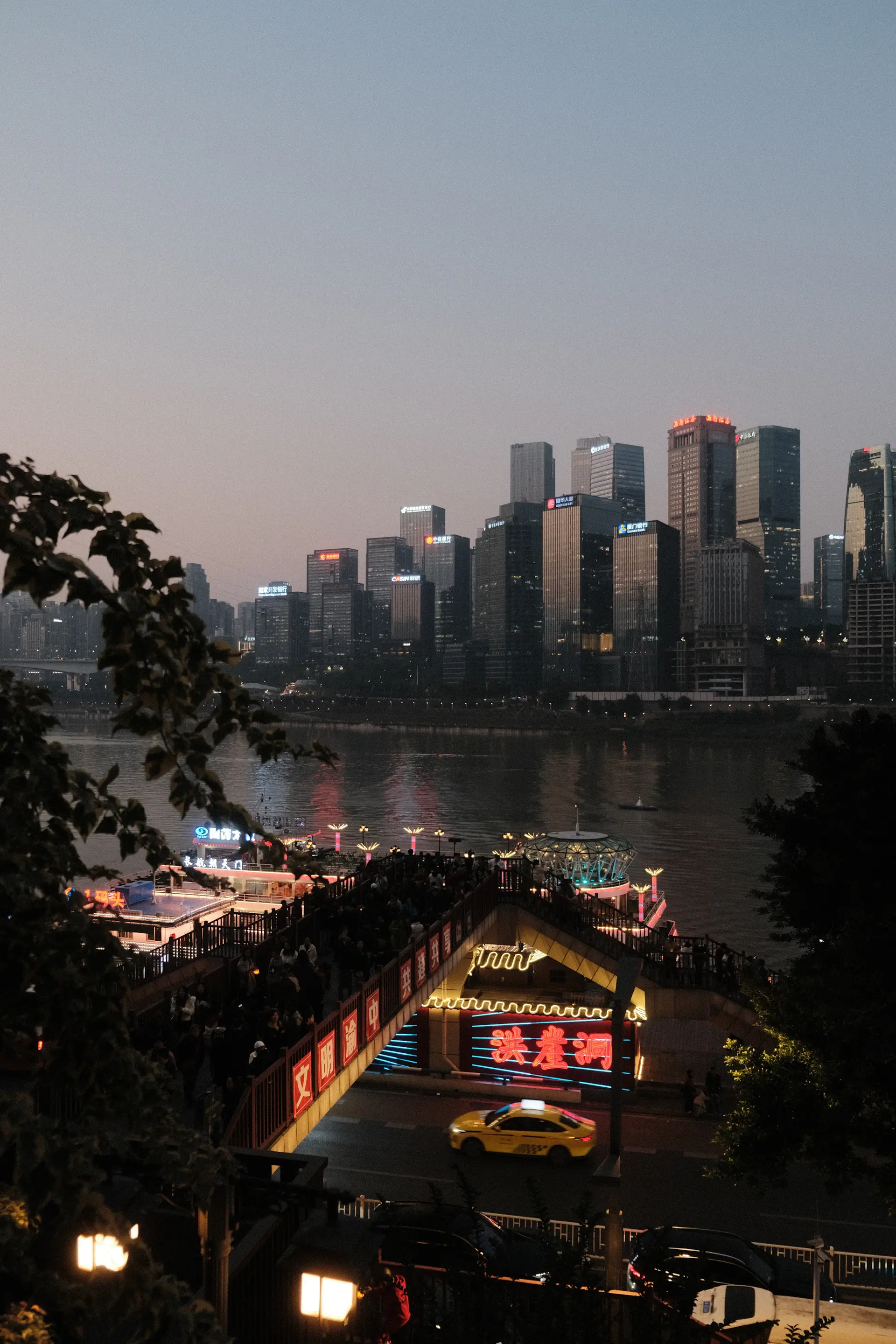 A rooftop pavilion overlooking a glittering city skyline at dusk