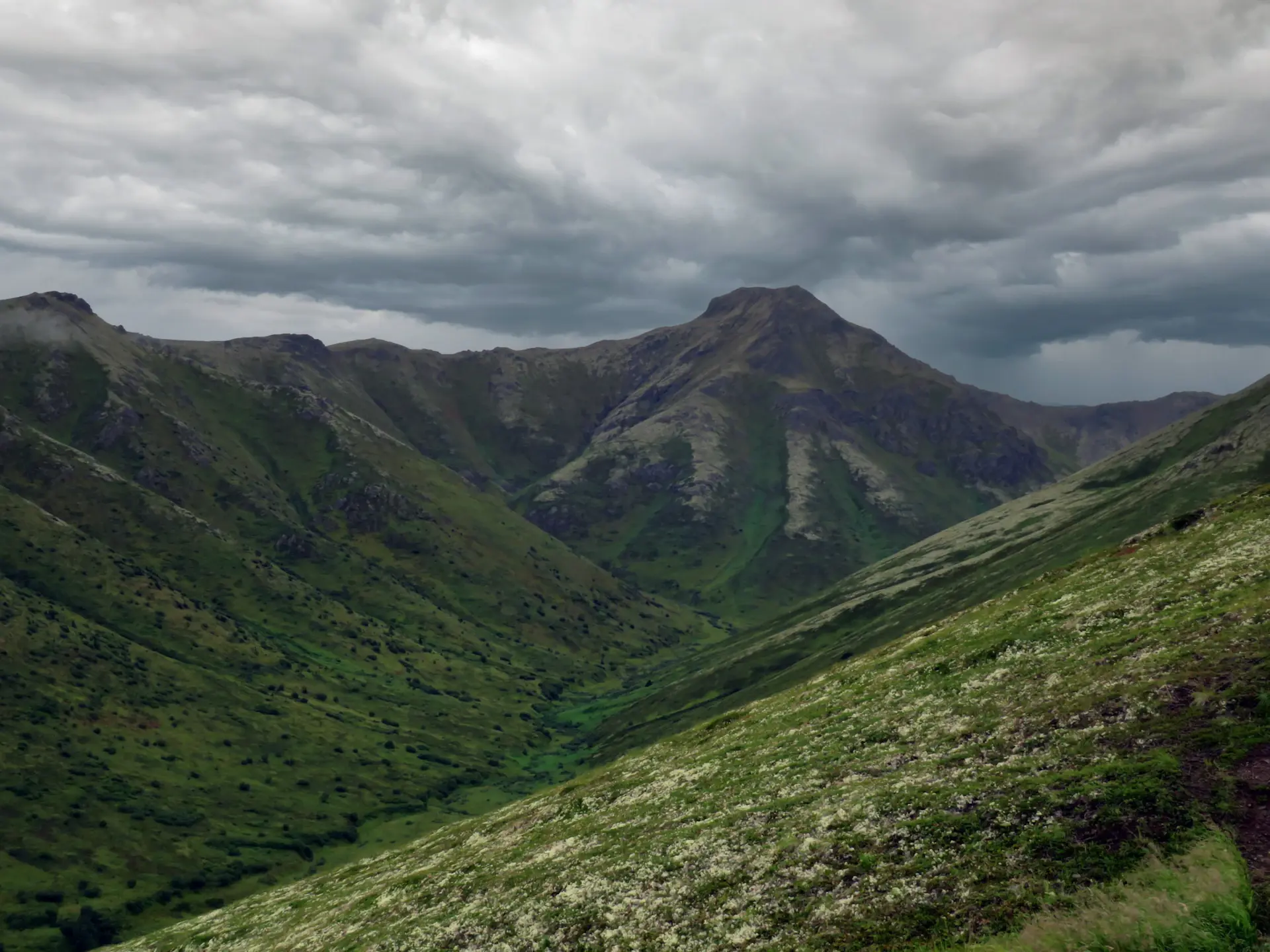 Dark storm clouds gathering over an exposed ridgeline