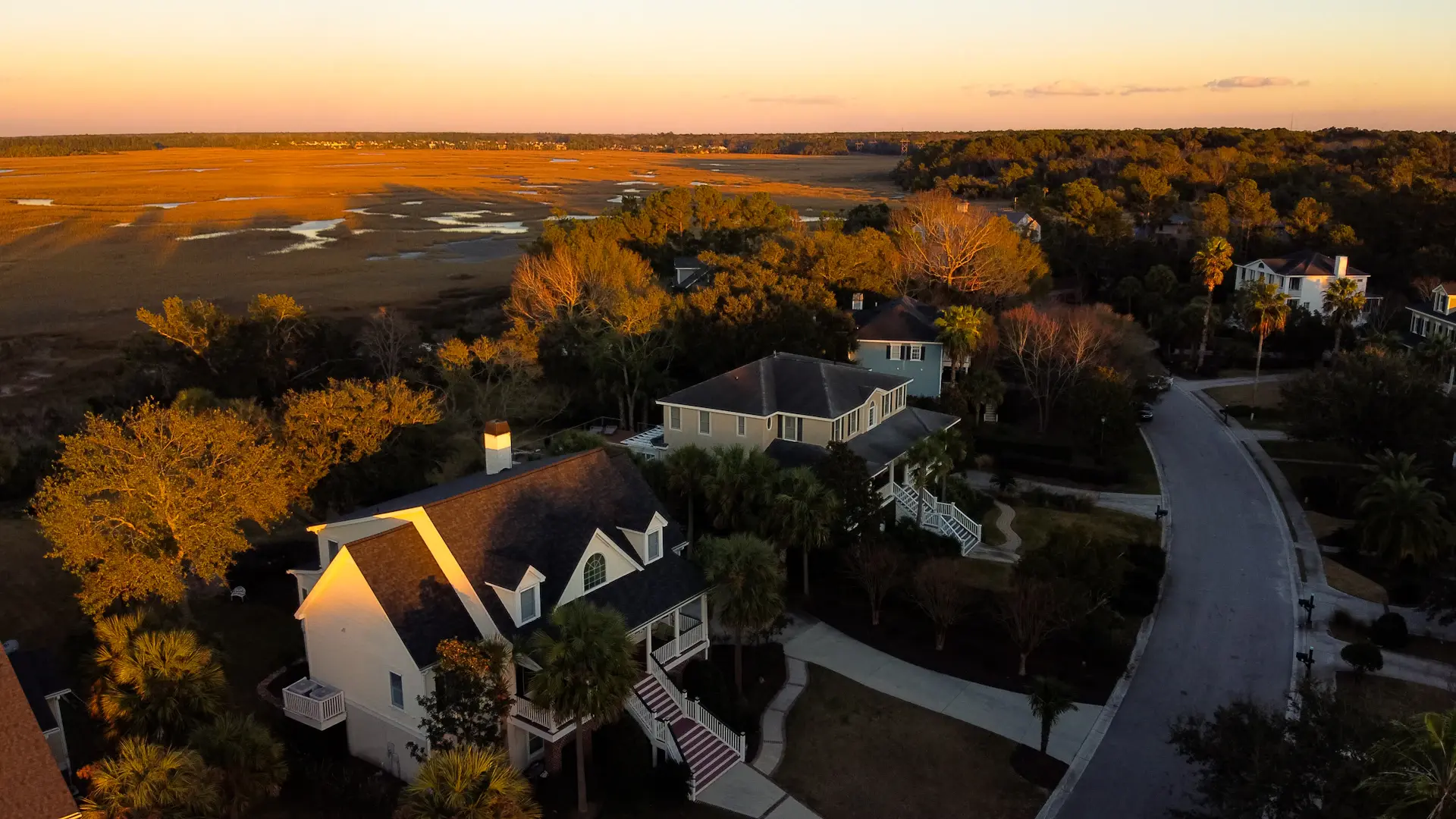 Aerial view of a private waterfront estate at golden hour