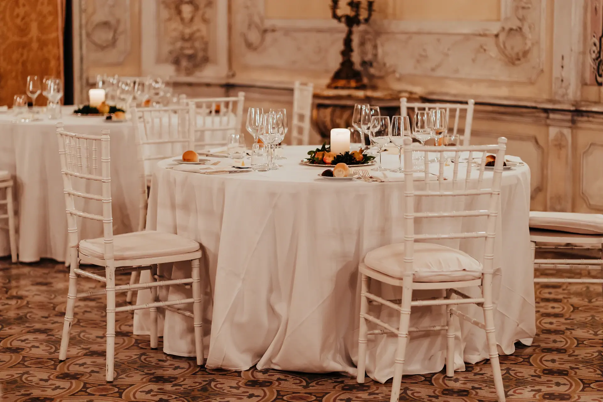 An ornate banquet table dressed in white and gold