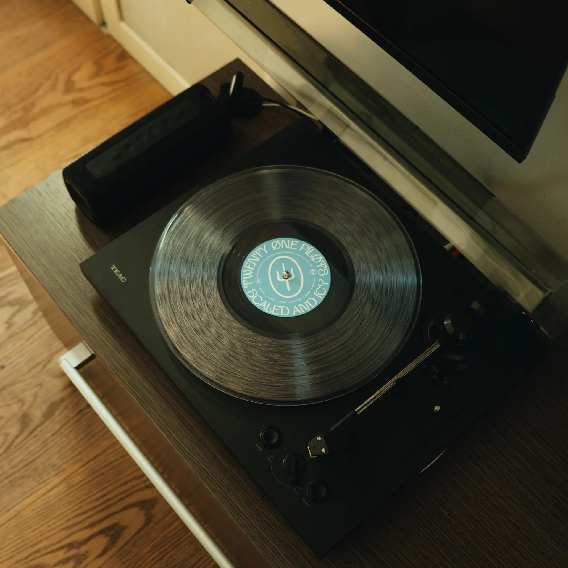 Vinyl records stacked beside a turntable