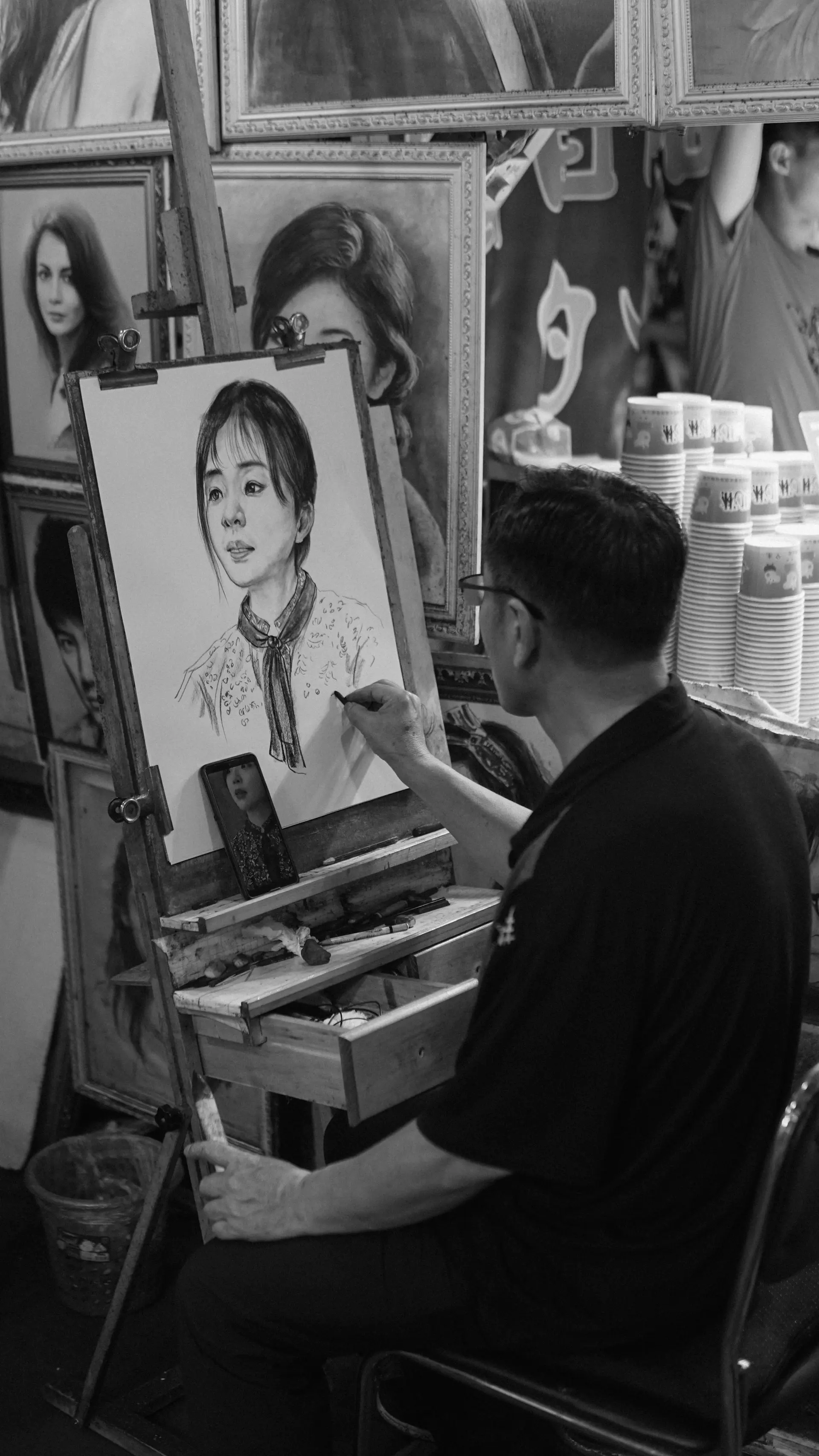 Monochrome portrait of a distinguished master coachbuilder in the atelier