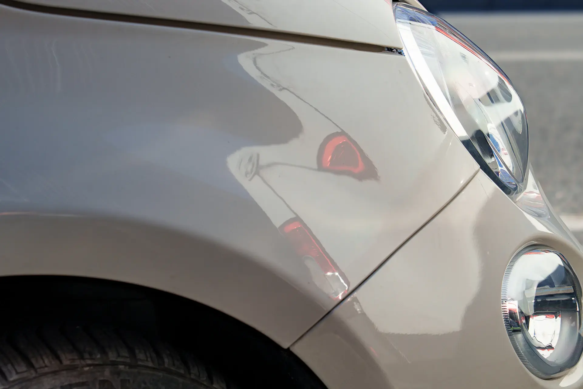 Close-up of champagne gold metallic paint on a car body