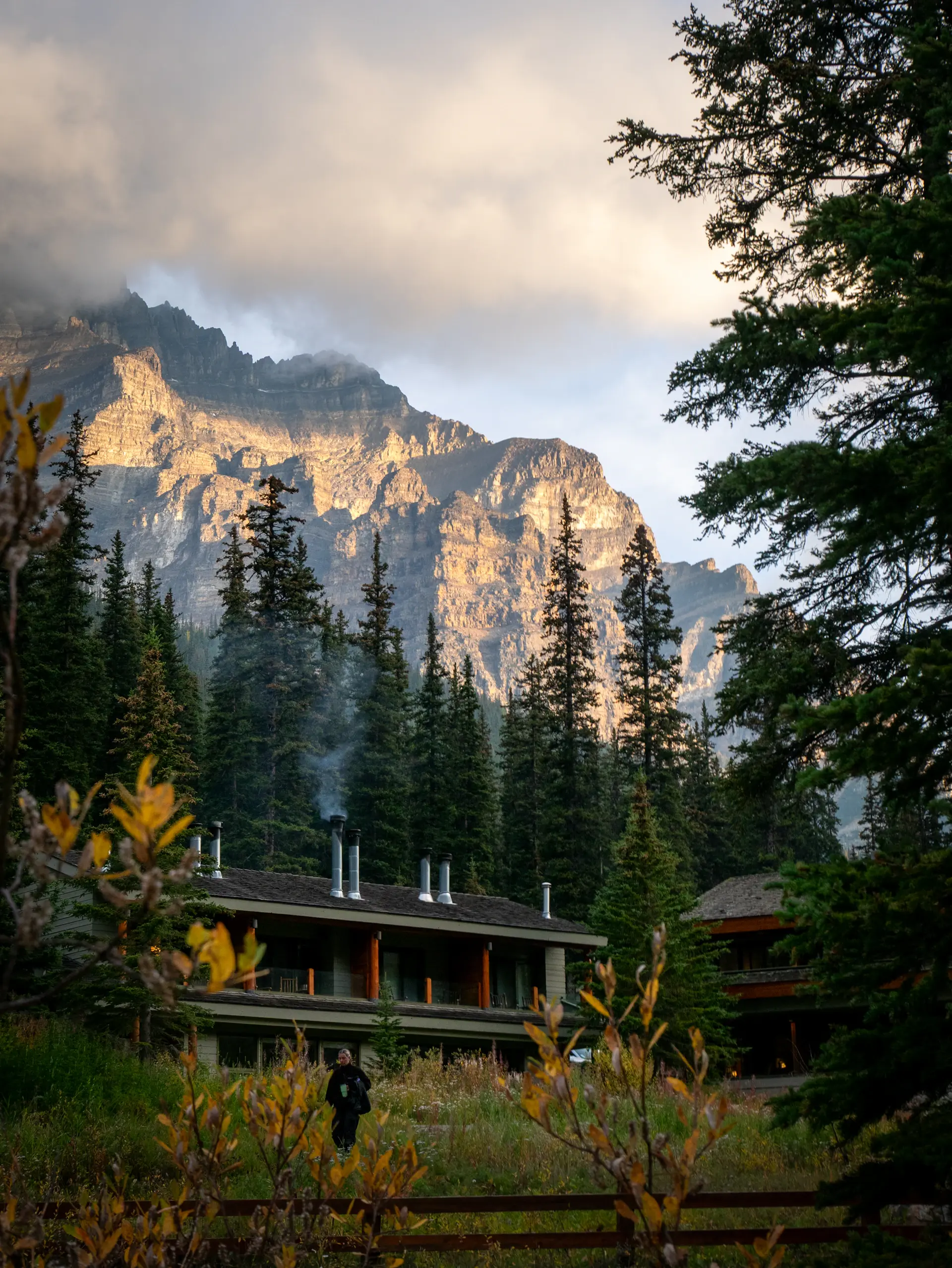 A remote lodge framed by mountains at dusk