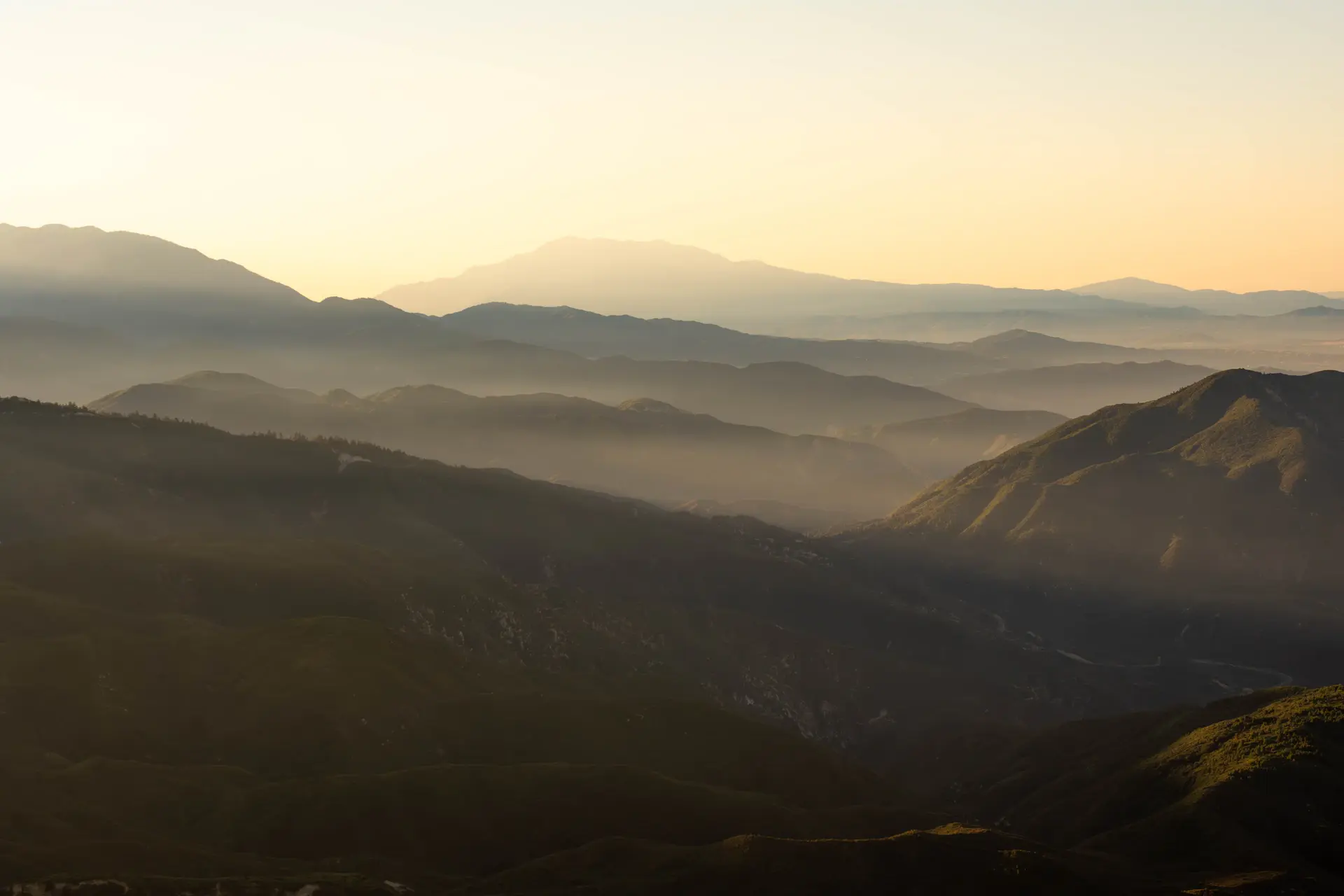 A vast misty wilderness fading into pale distant light