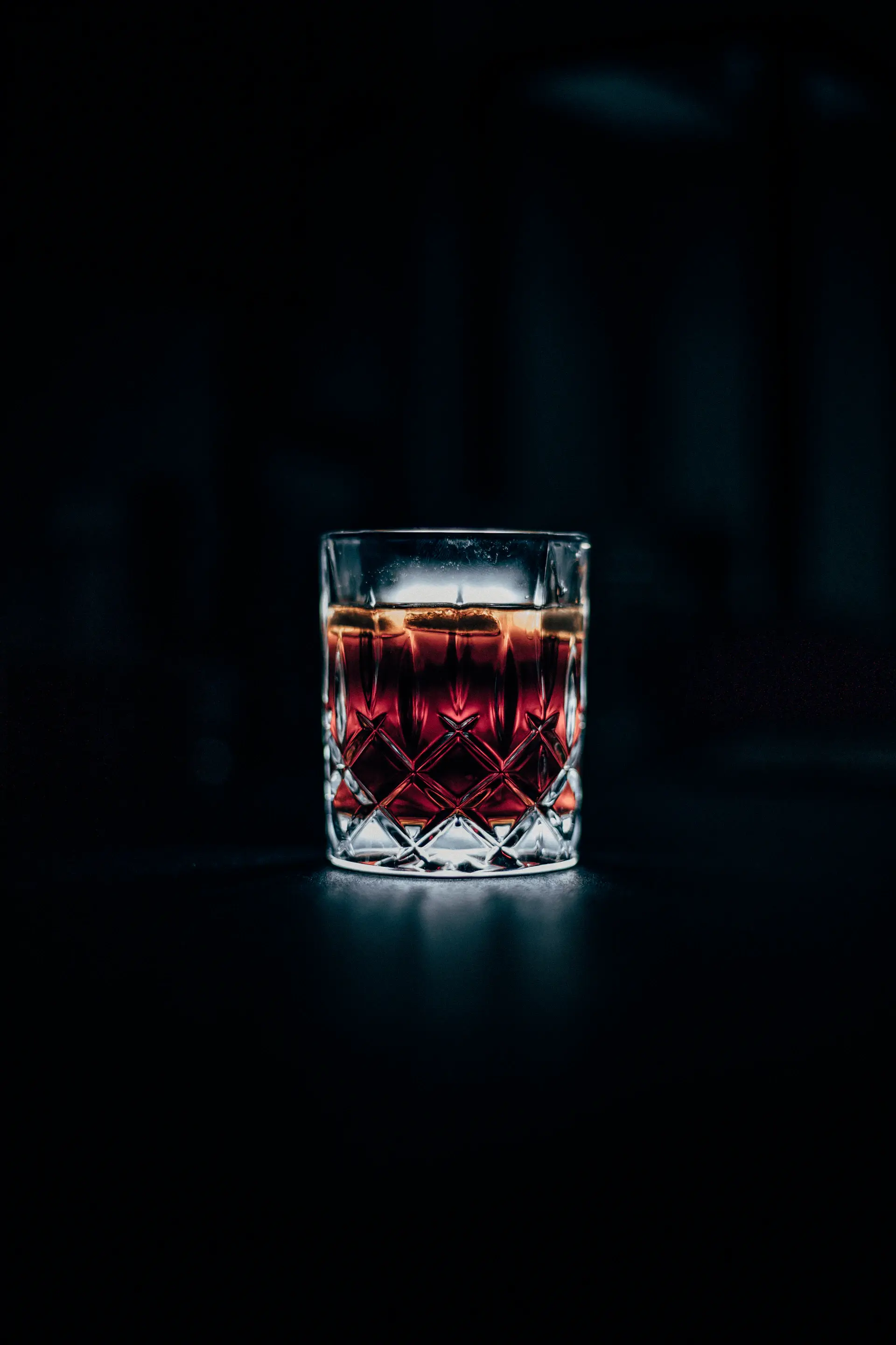 Single malt whisky in a crystal glass beside the bottle