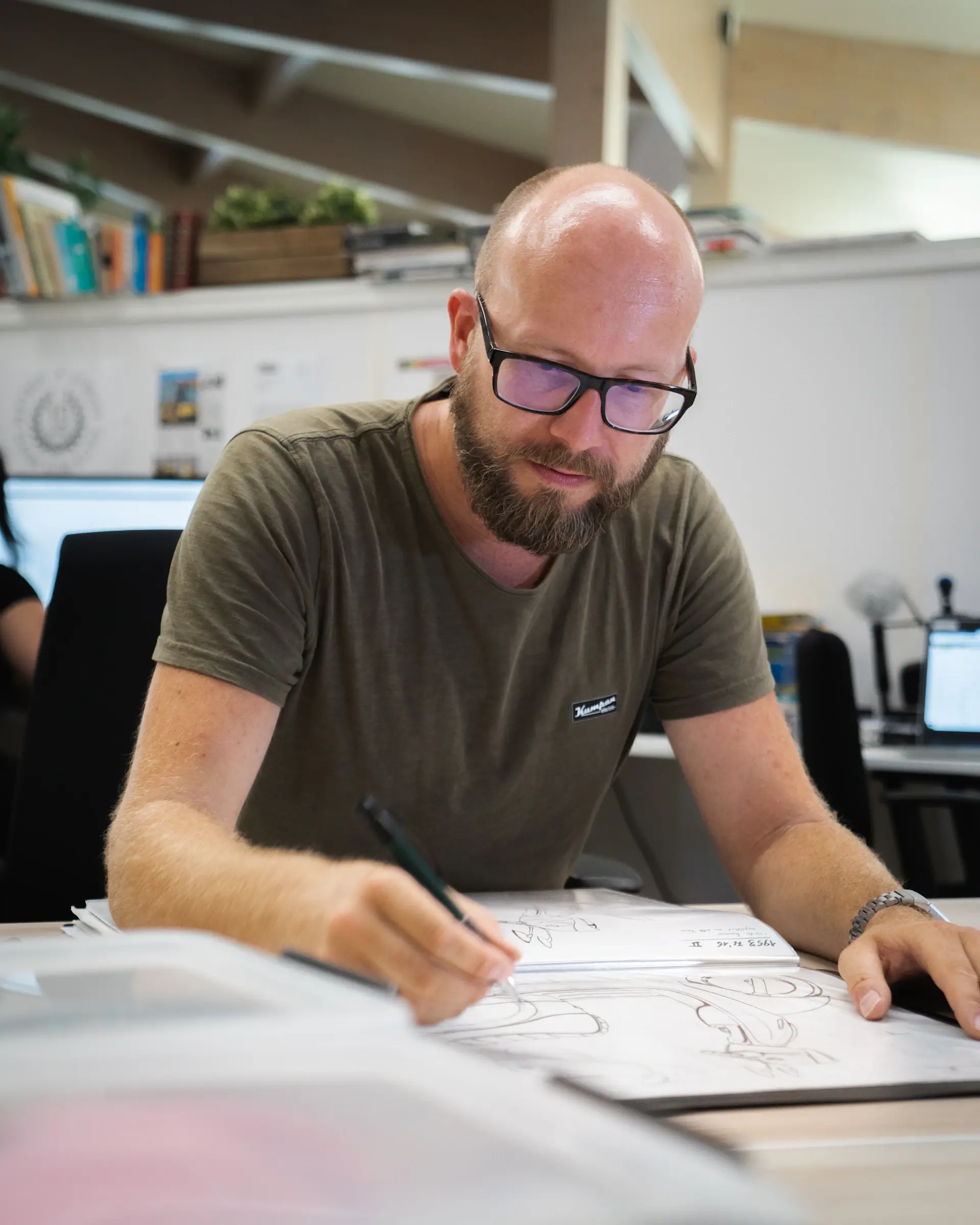 Designer sketching the lines of a luxury coupe