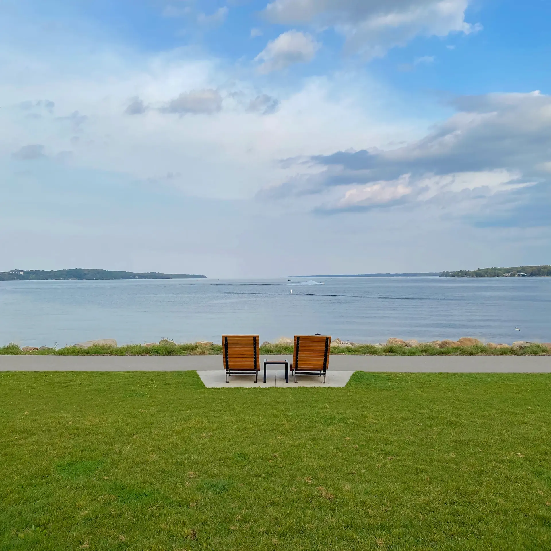 Sunlit estate terrace overlooking water
