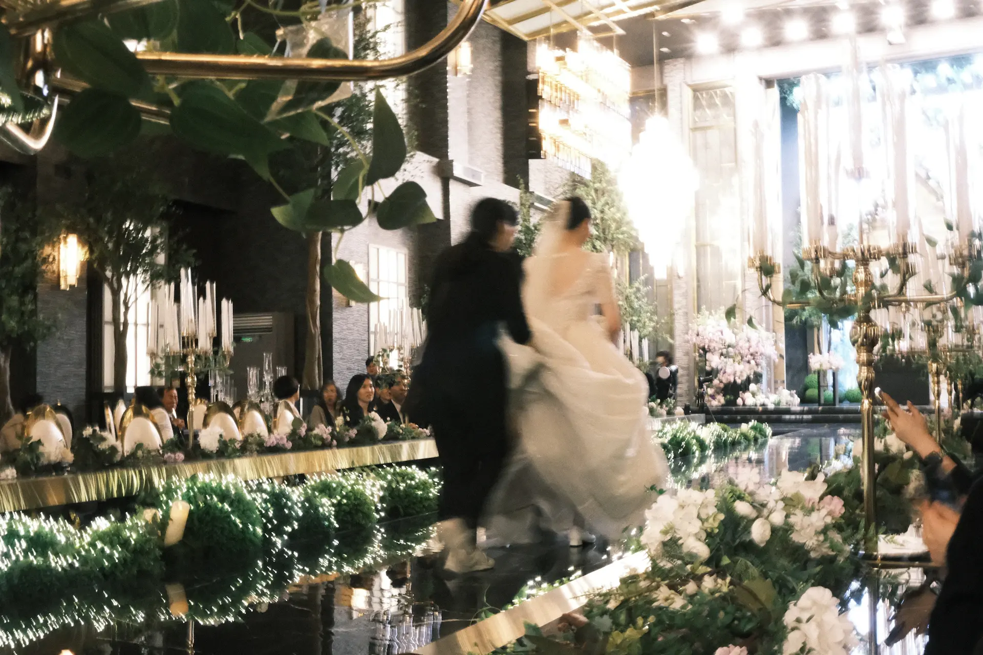 Aria and Sebastian sharing their first dance beneath chandeliers in the Grand Ballroom