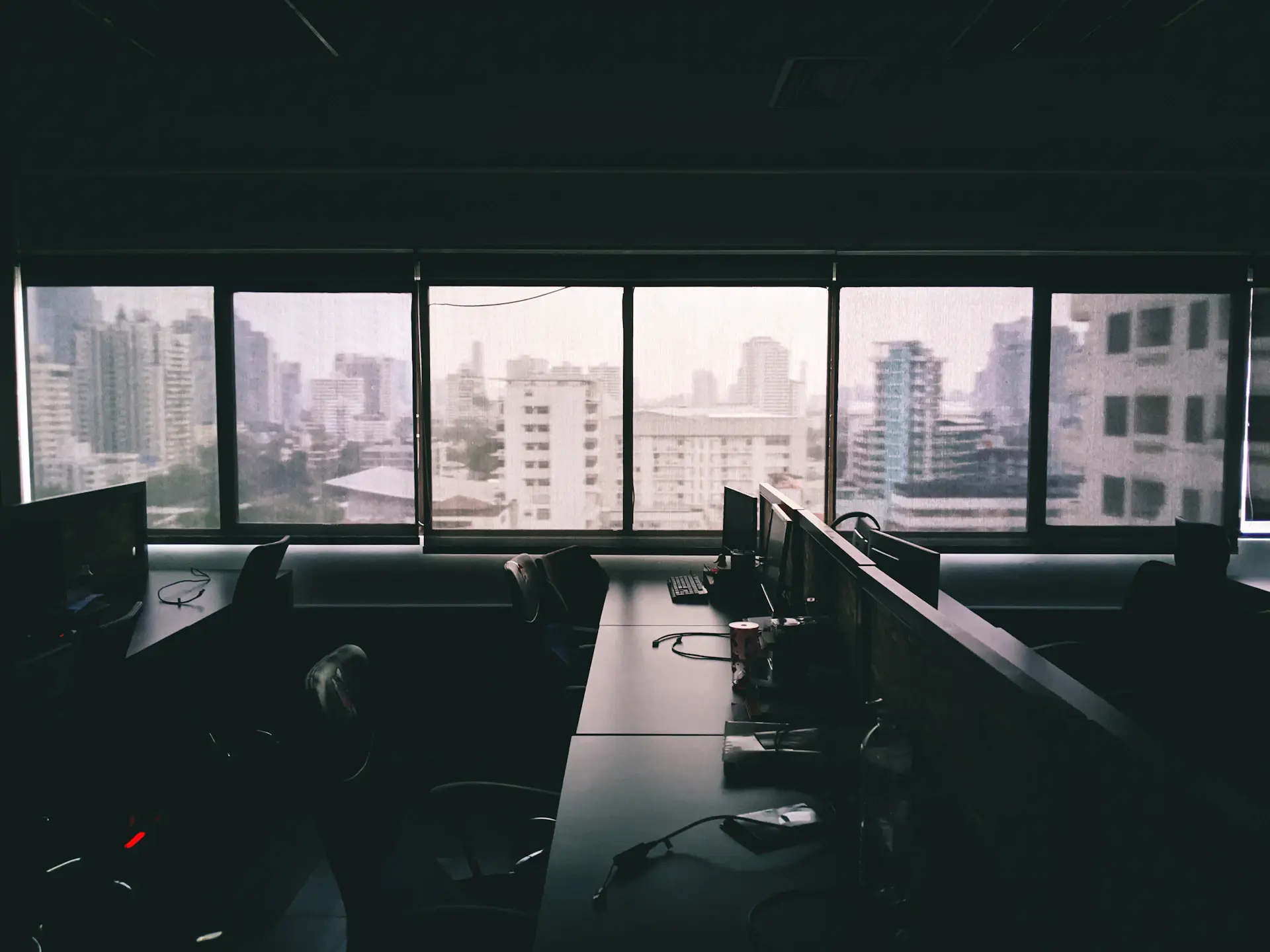 Dark workspace with multiple code editor screens glowing