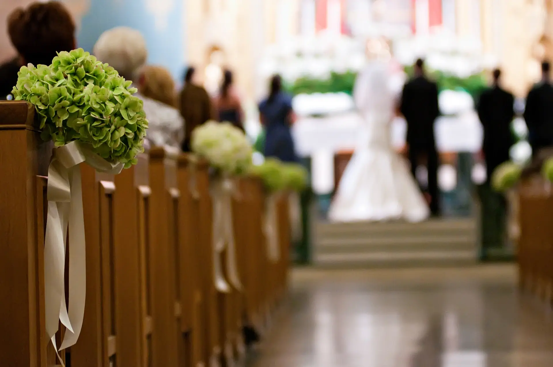 Candlelit wedding ceremony beneath crystal chandeliers in a grand ballroom