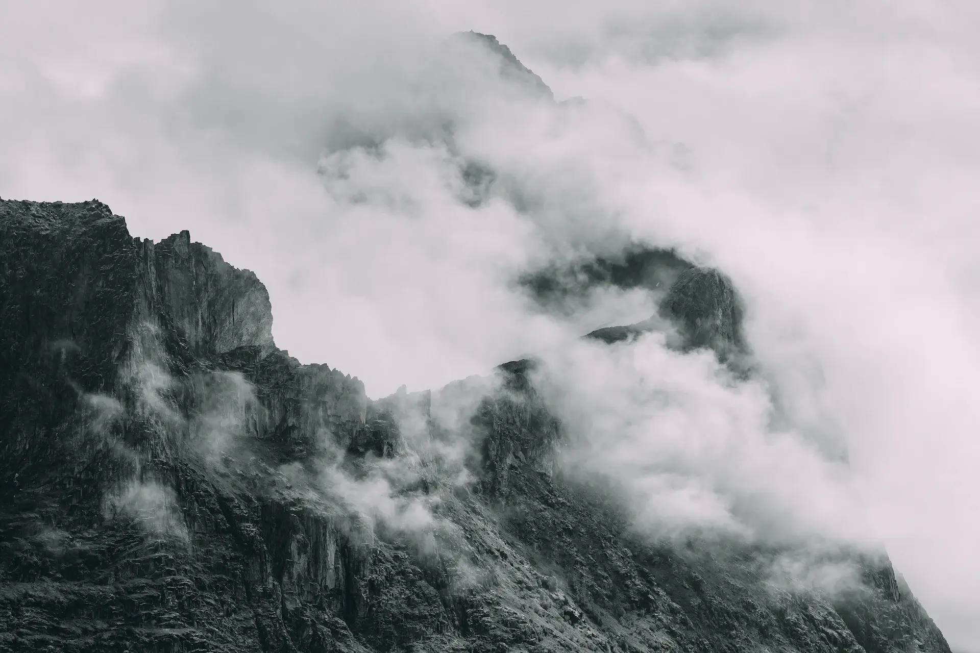 Snow-dusted alpine ridgeline above a sea of cloud