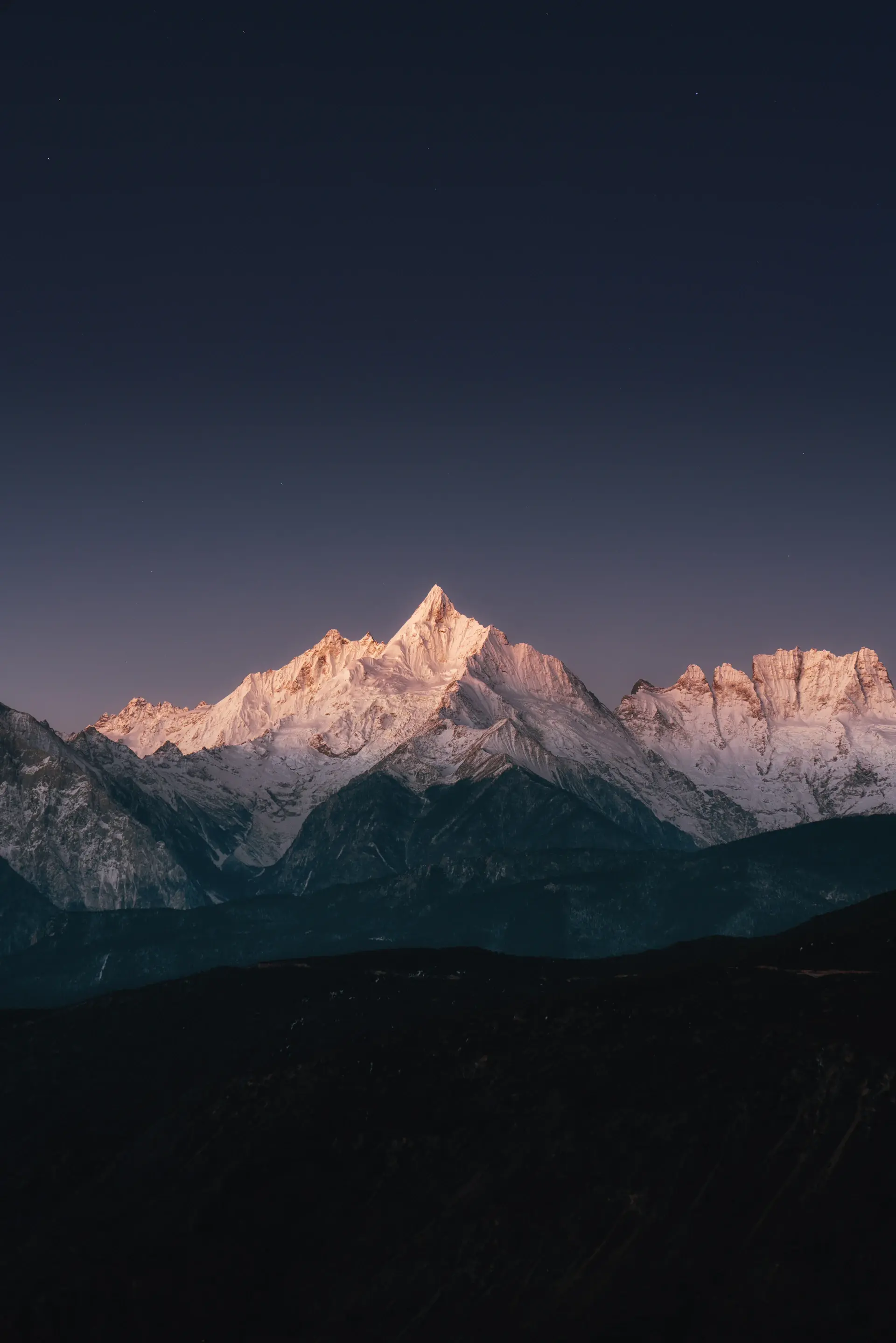 Snow peaks rising through morning mist