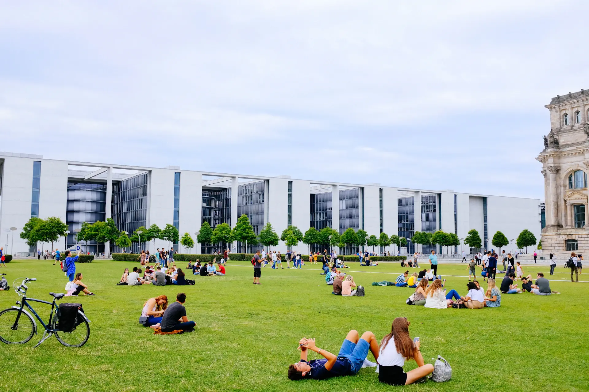 Modern Korean university campus building with students