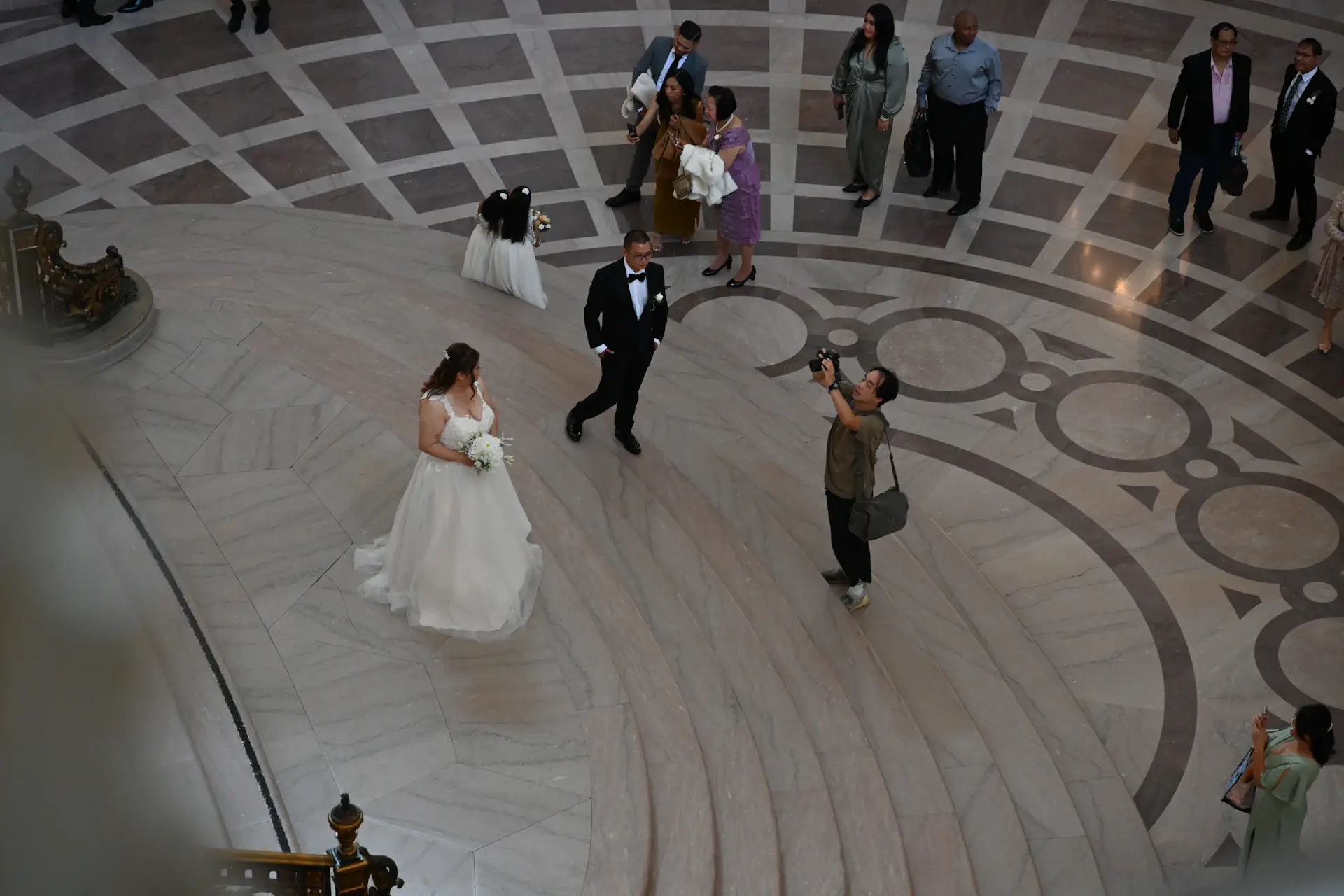 A bride and groom sharing their first dance on the marble floor
