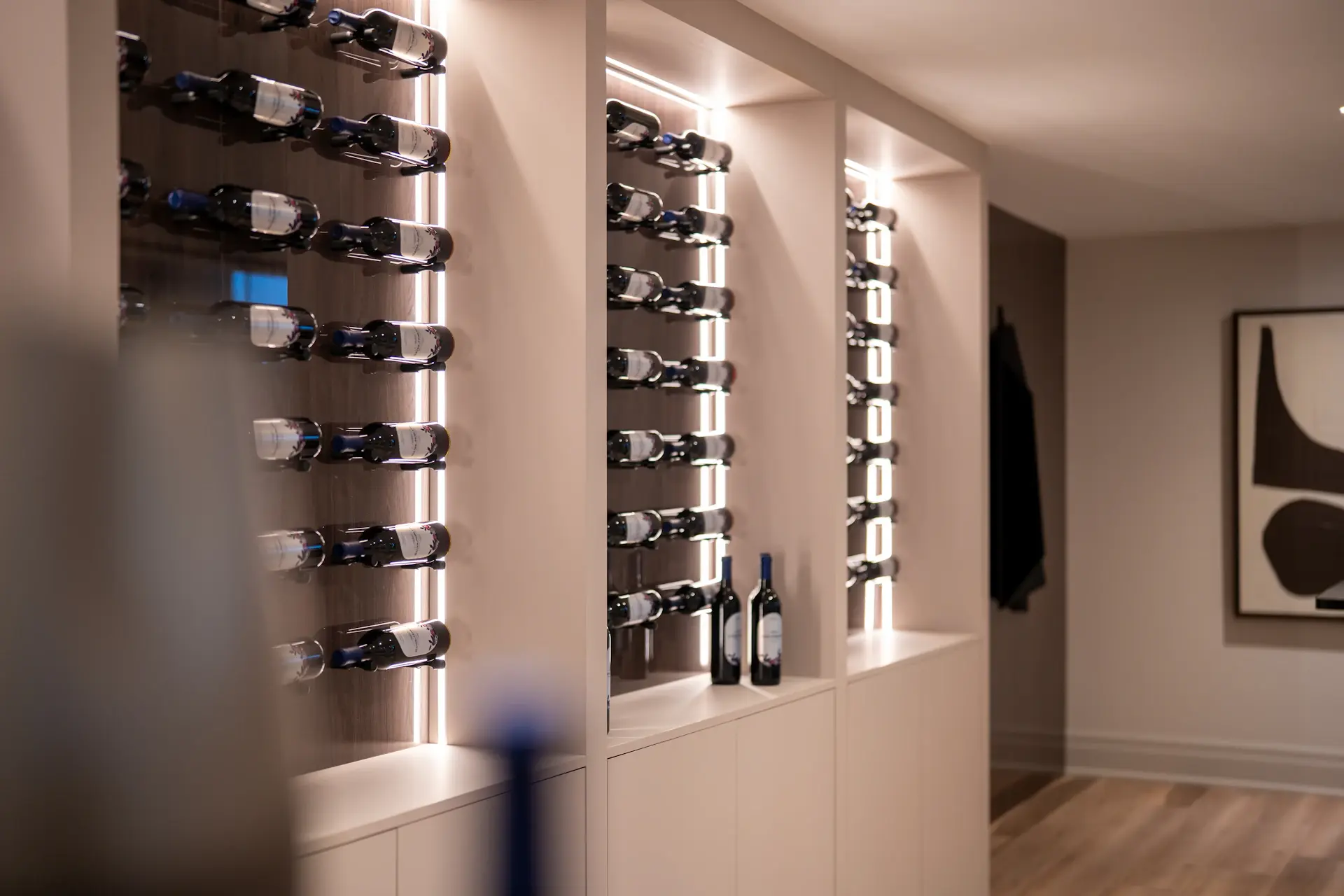 Dimly lit private cellar lined with rare bottles and warm amber light
