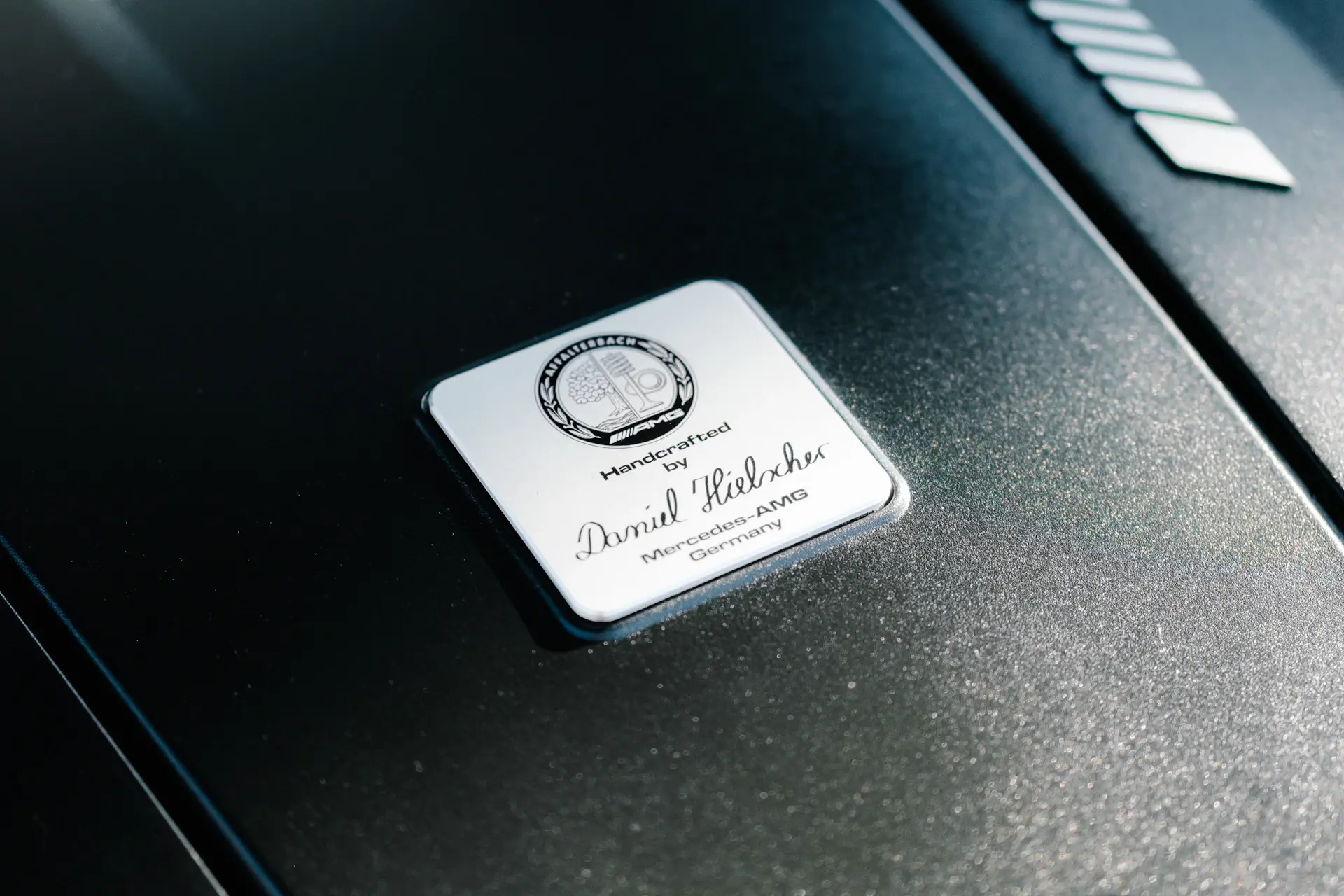 Engraved metal nameplate on a luxury motorcar