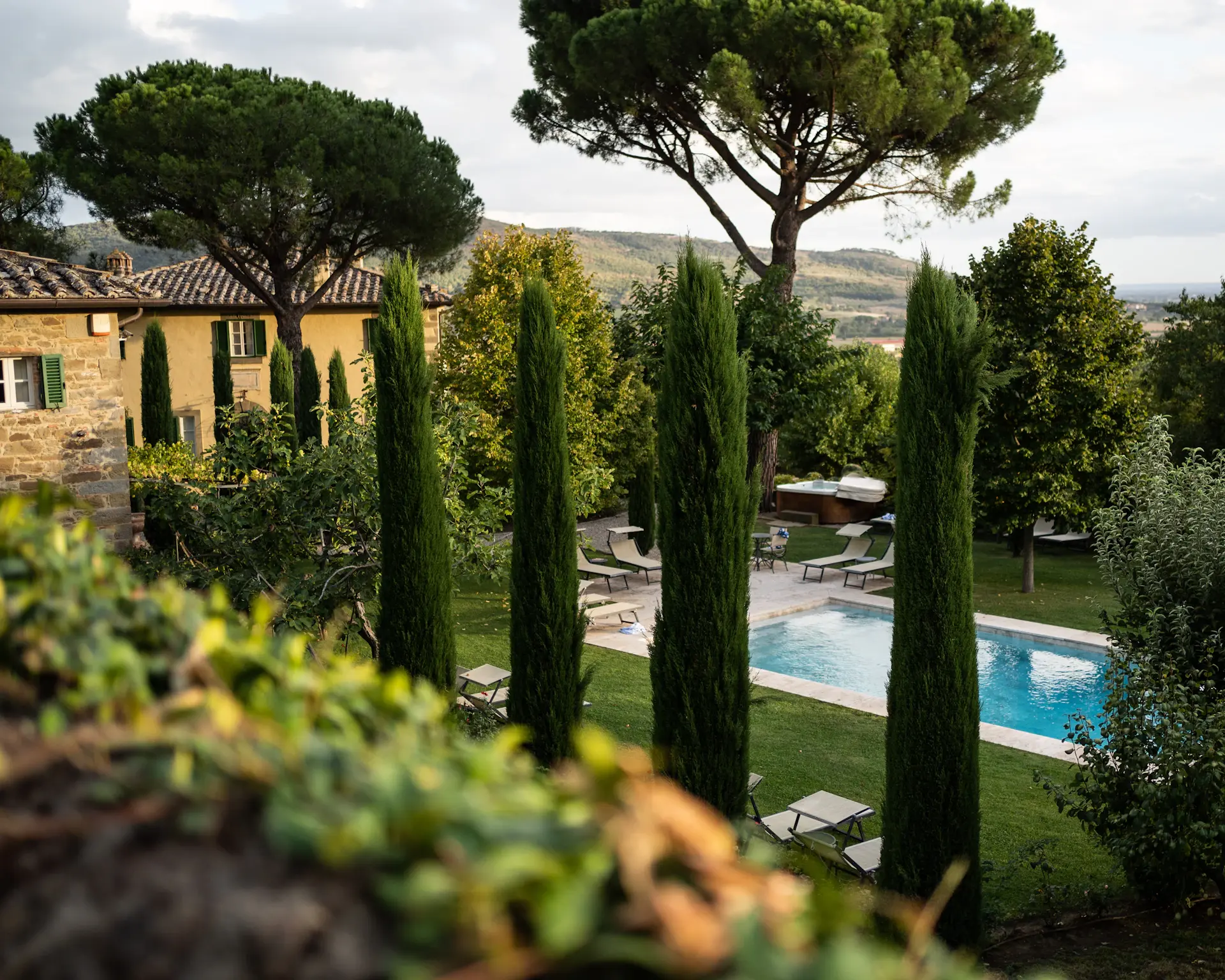 Hillside stone estate surrounded by pine trees