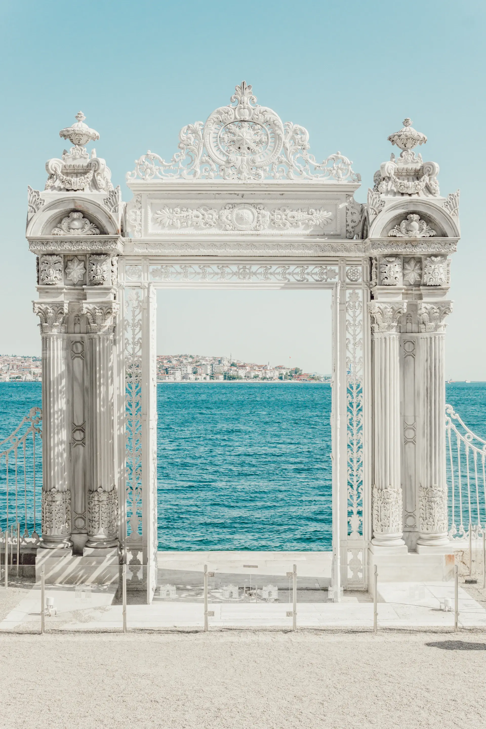 A grand palace ceremony arch dressed in white and blush florals