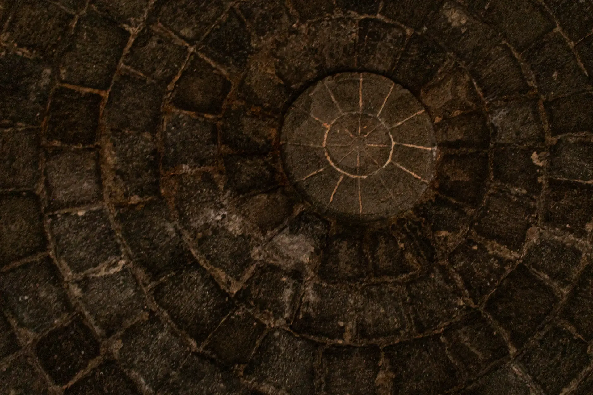 Aged oak casks resting in a stone heritage cellar