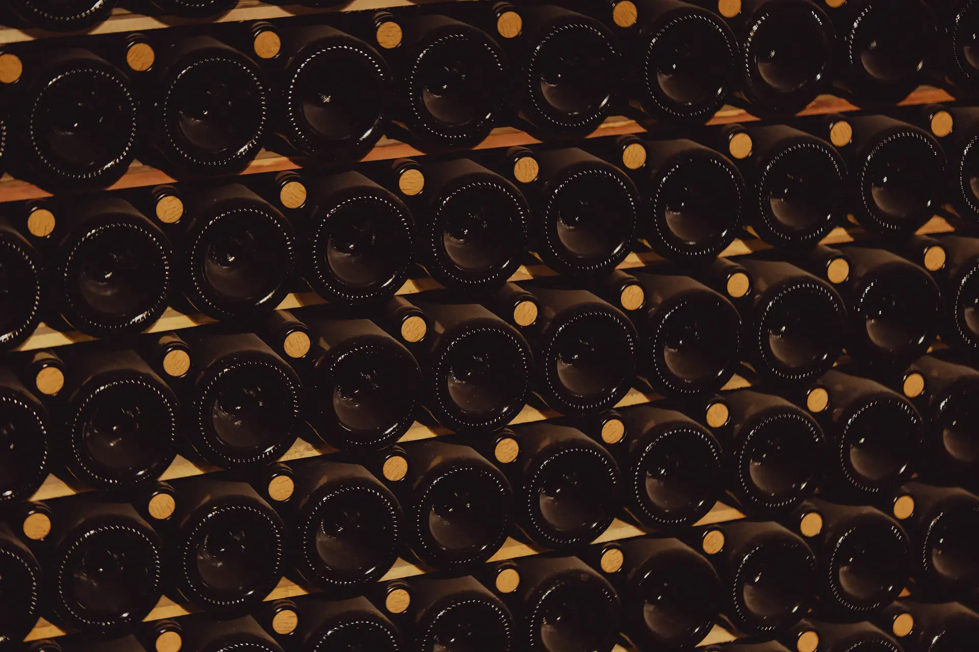 A candlelit heritage cellar lined with aged oak barrels