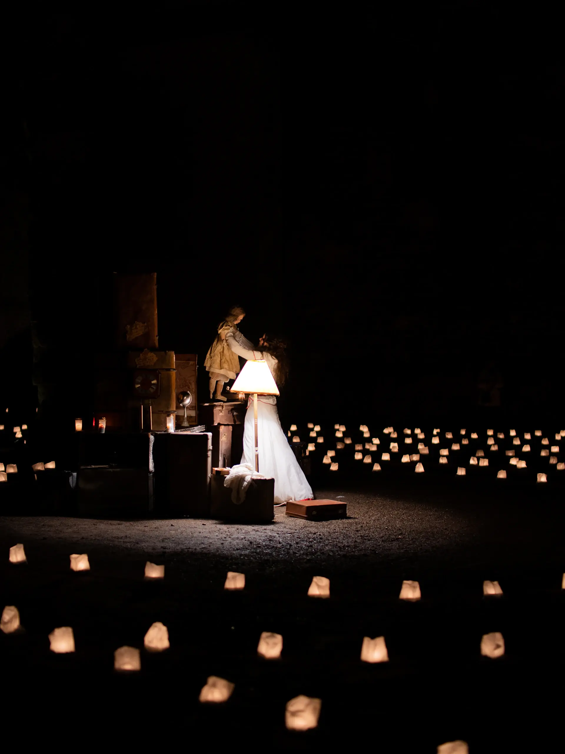 Bride and groom beneath a candlelit archway