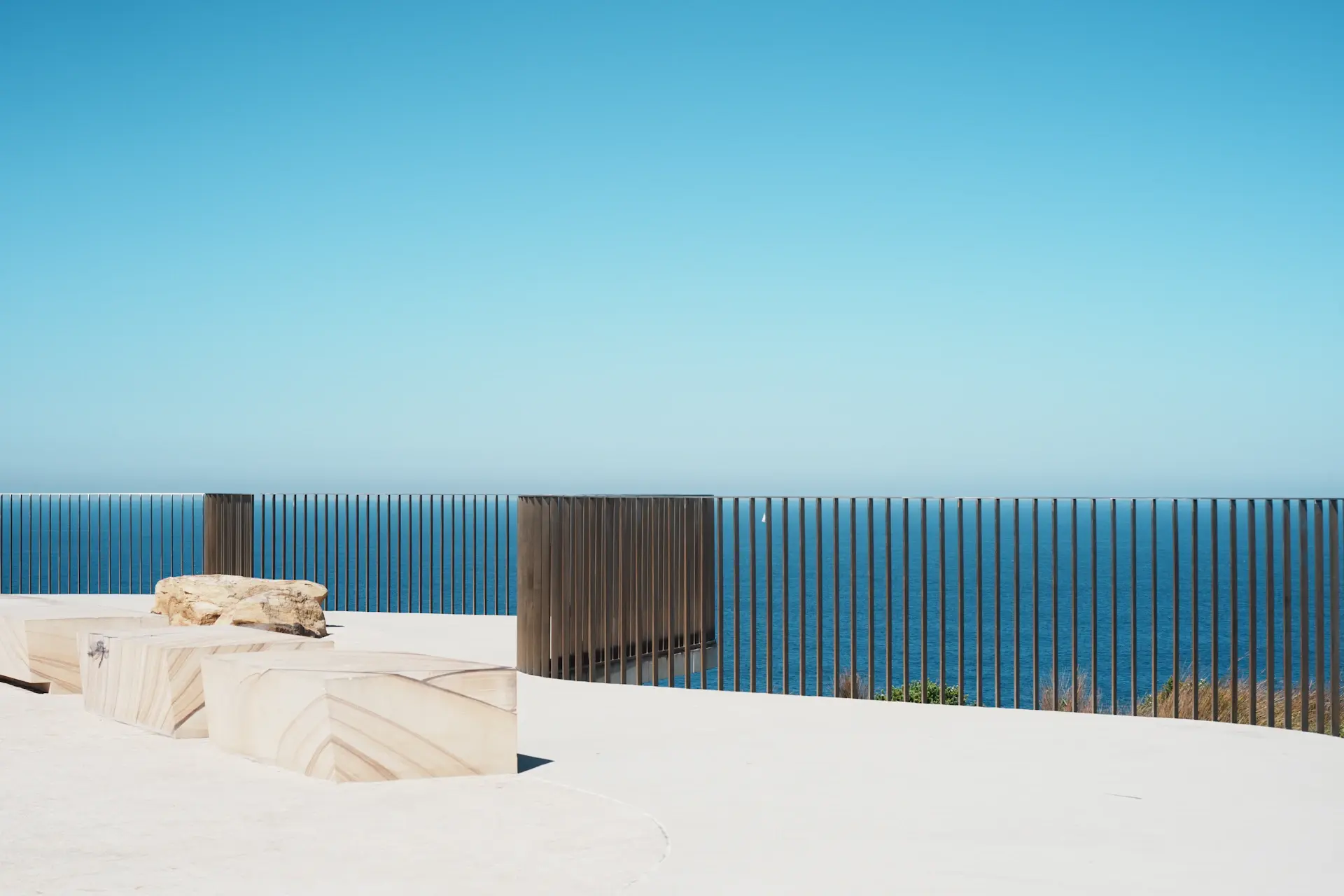 First light spilling across an empty terrace overlooking a still sea