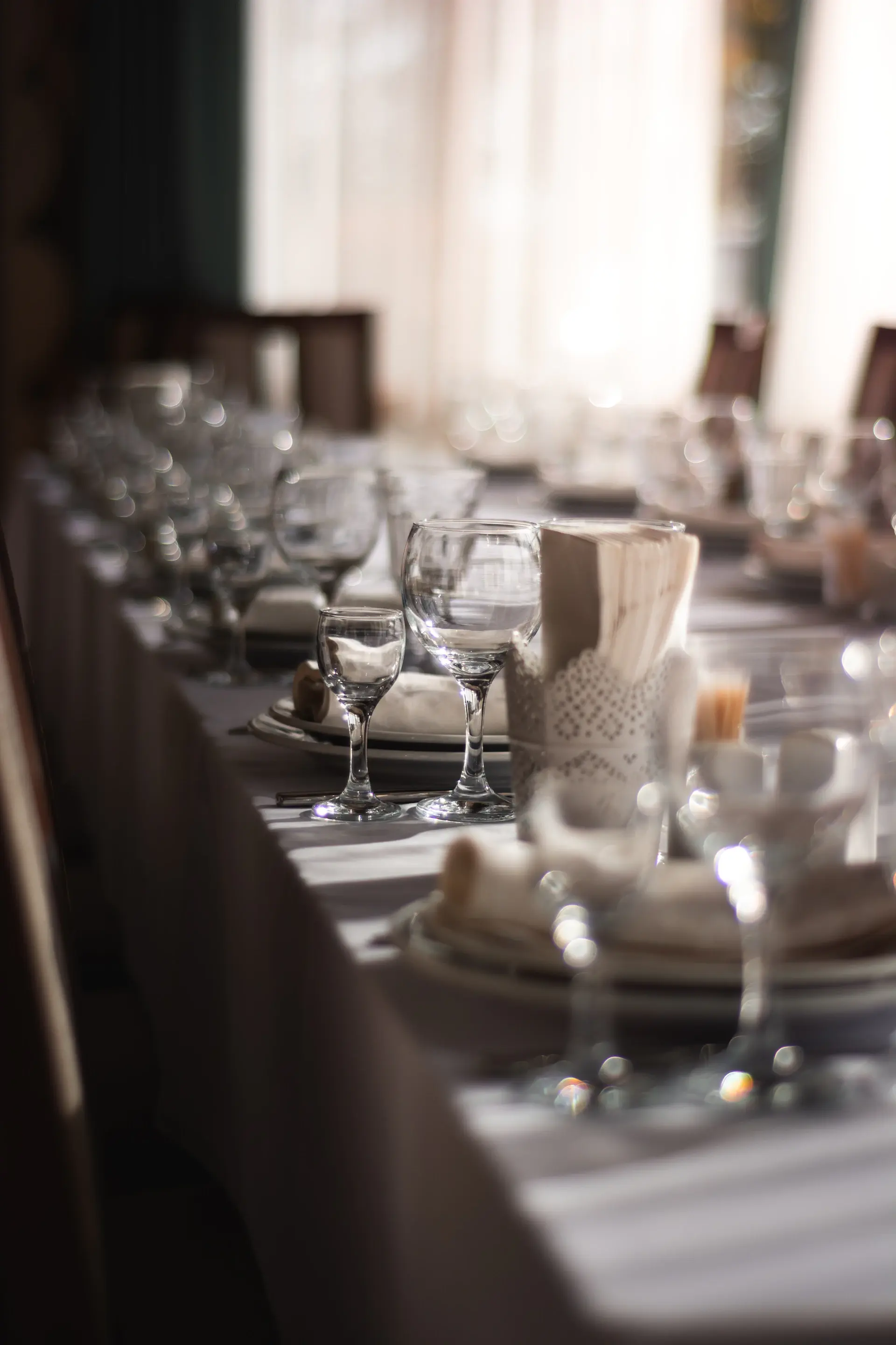 A long banquet table set in ivory and gold