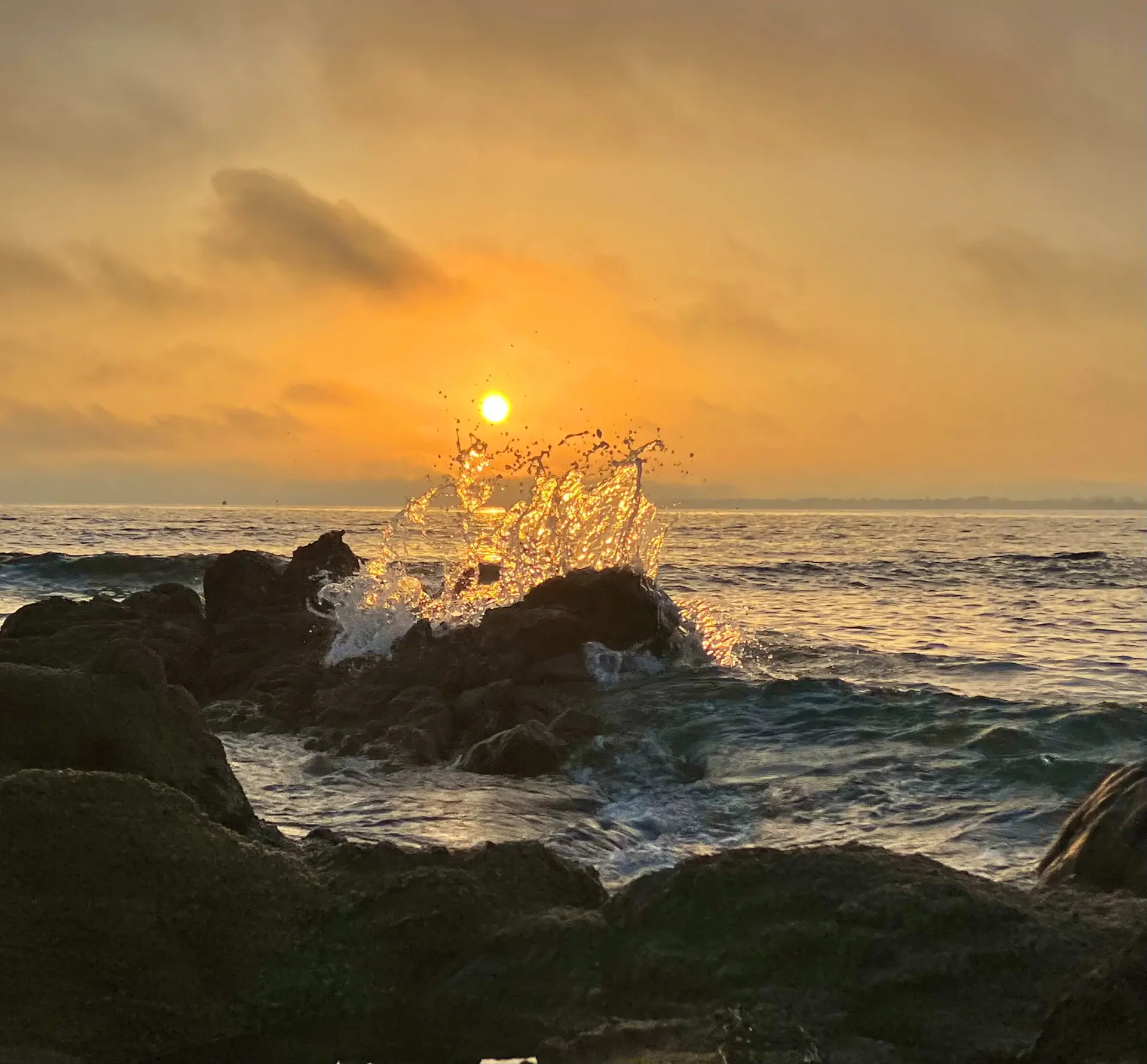 Warm dusk glow over a quiet rocky shore