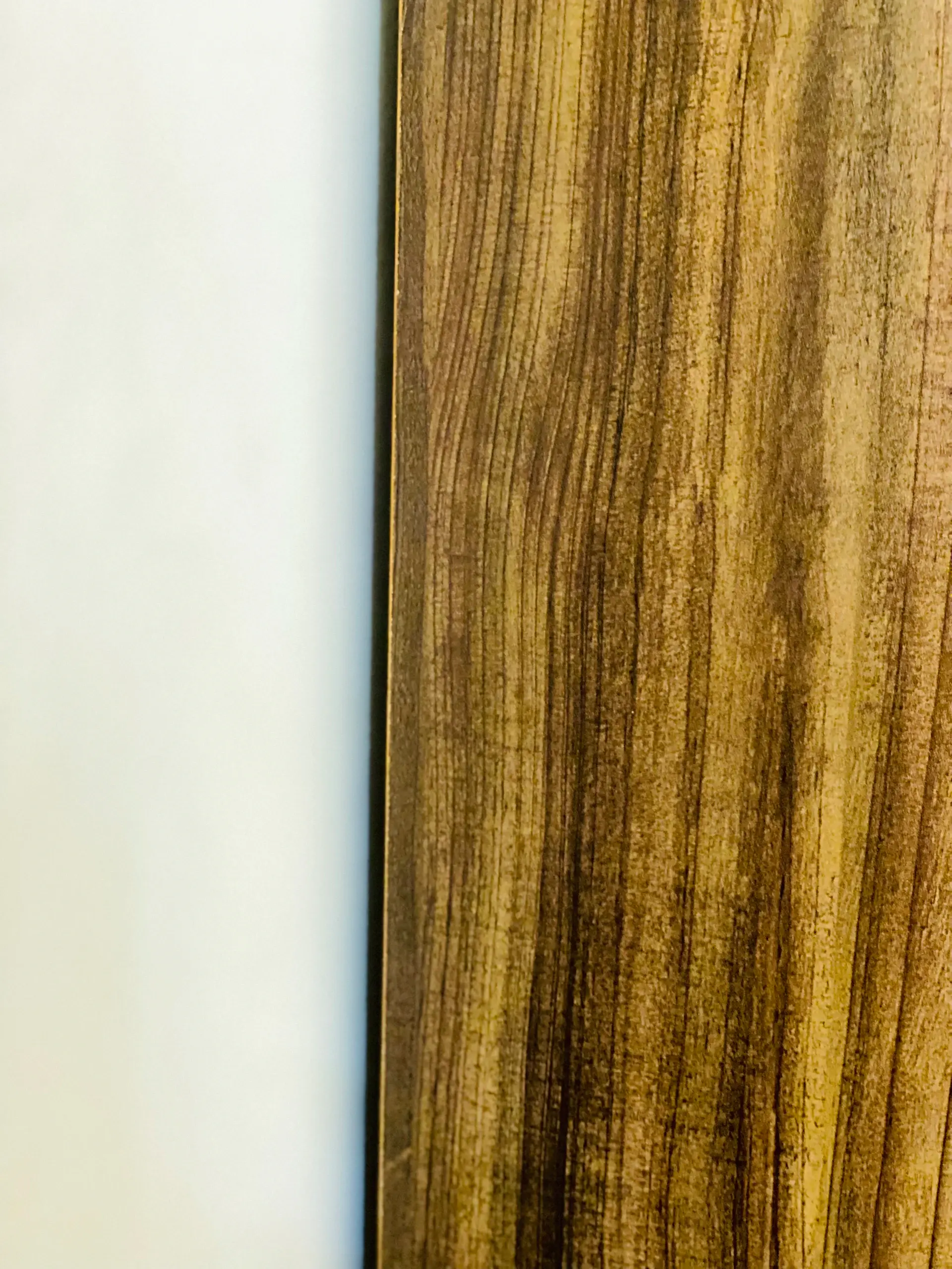 Master cabinetmaker finishing a polished walnut veneer panel
