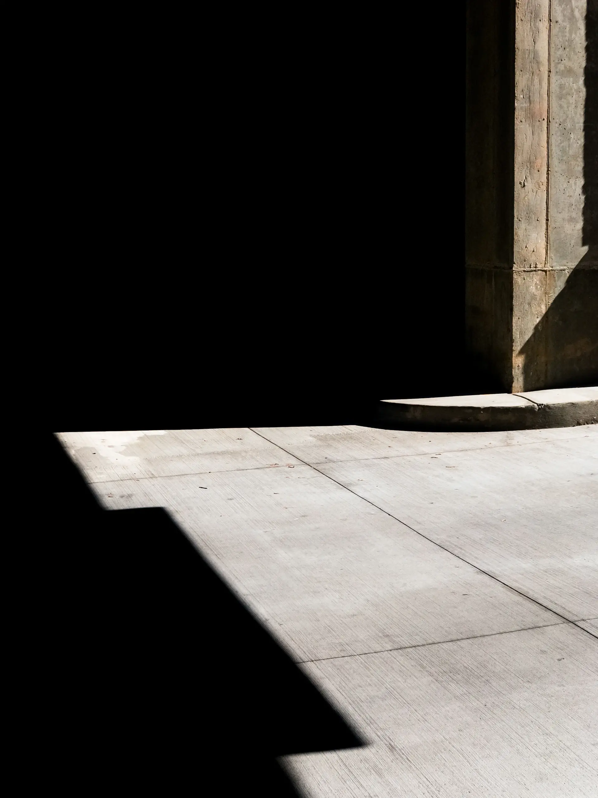 An architectural detail of stone, glass and shadow
